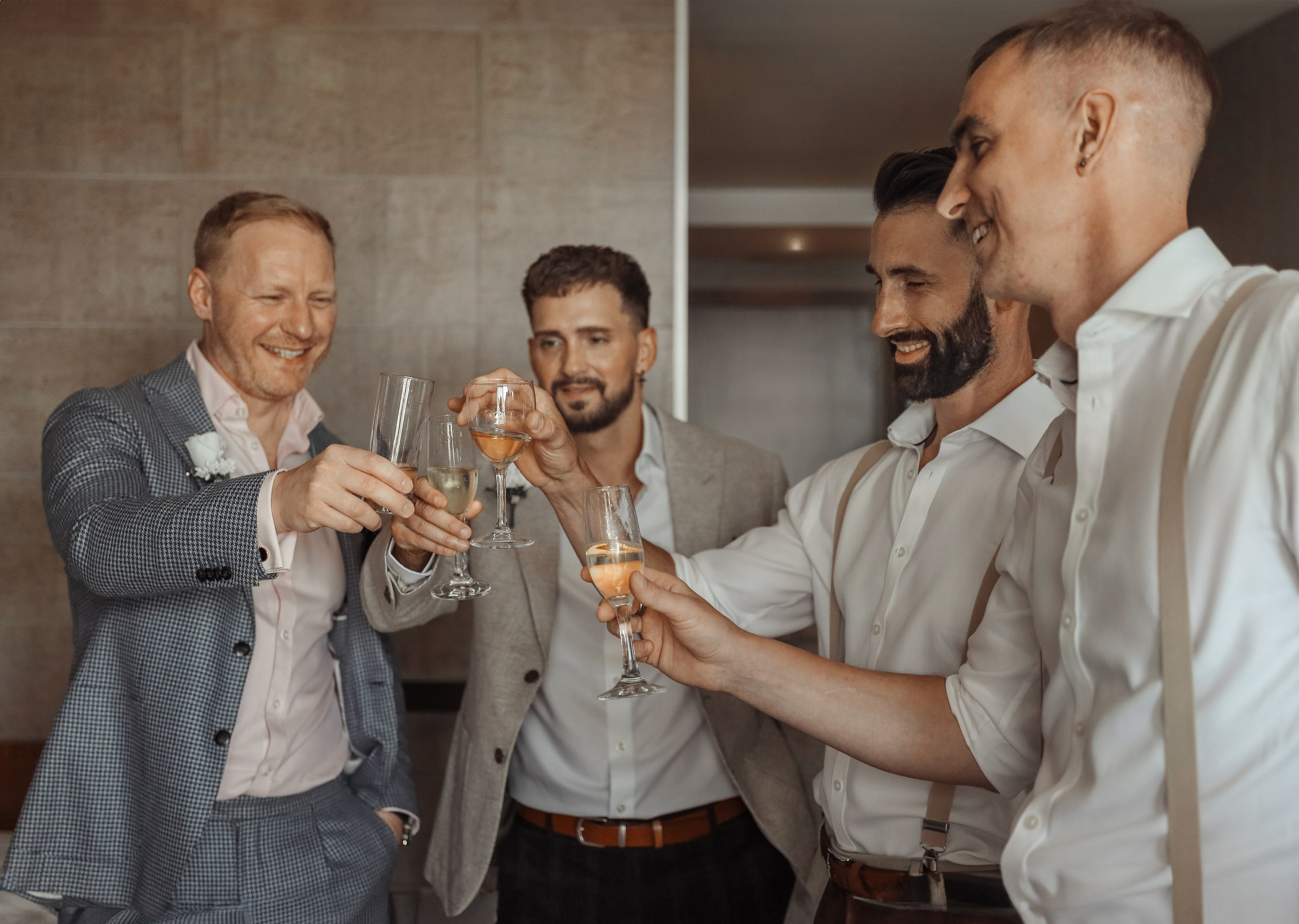 Group of friends enjoying drinks and sharing stories at a Groom getting ready for the wedding in a charming Sheraton hotel, Rhodes, Greece