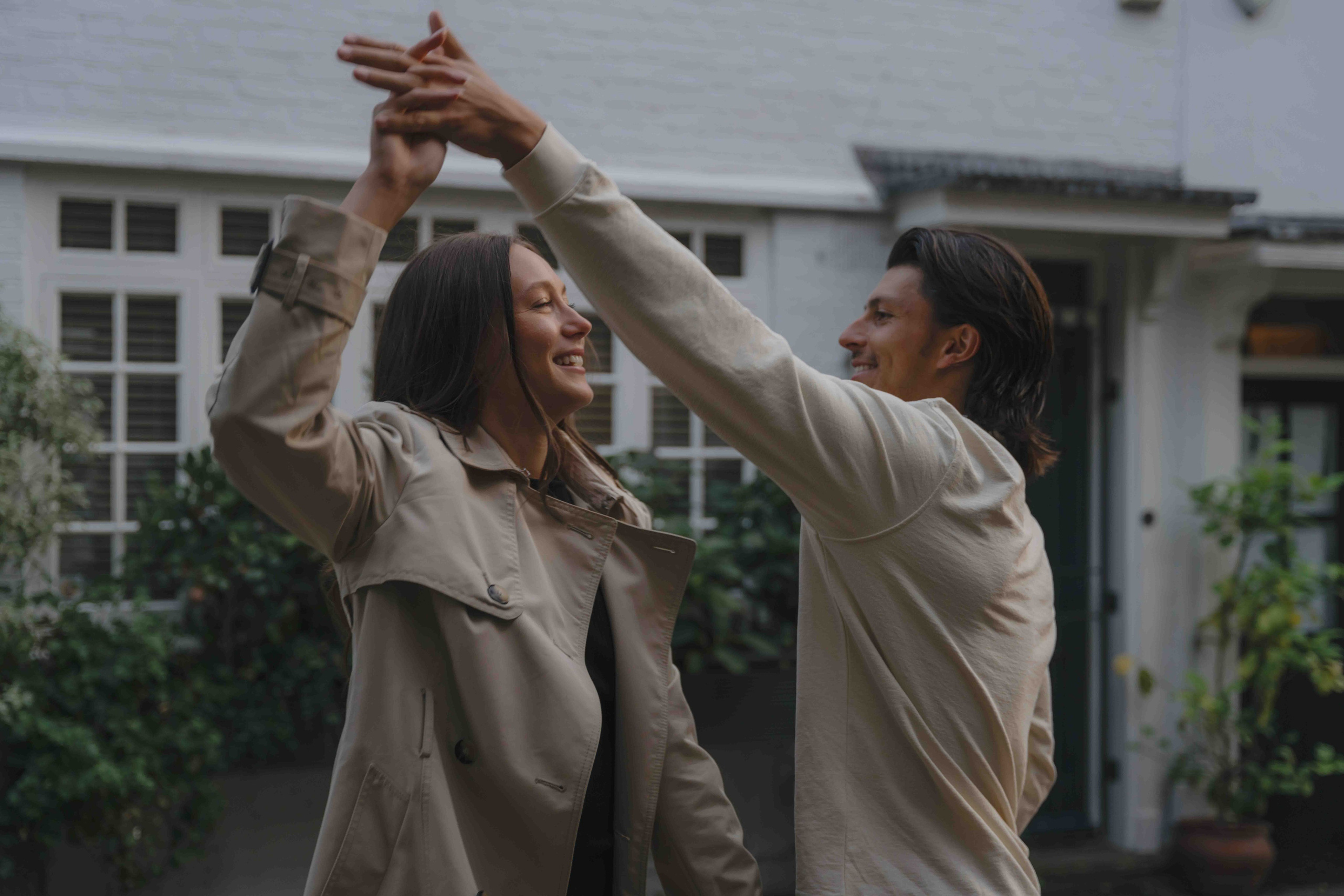 Playful couple movement London engagement photos natural candid style