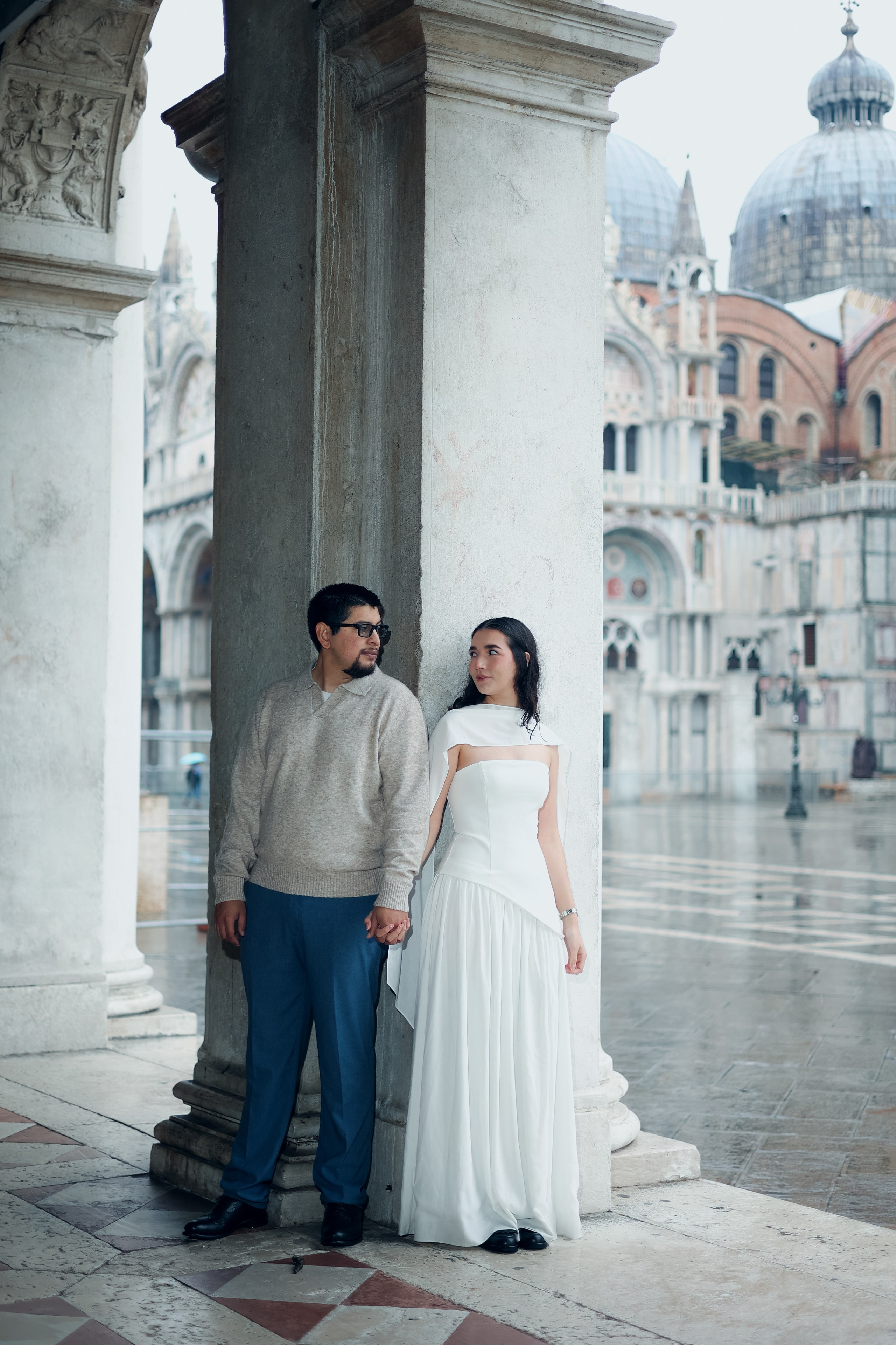 Rainy Venice couple photography — romantic travel portrait of two lovers walking through Venetian streets