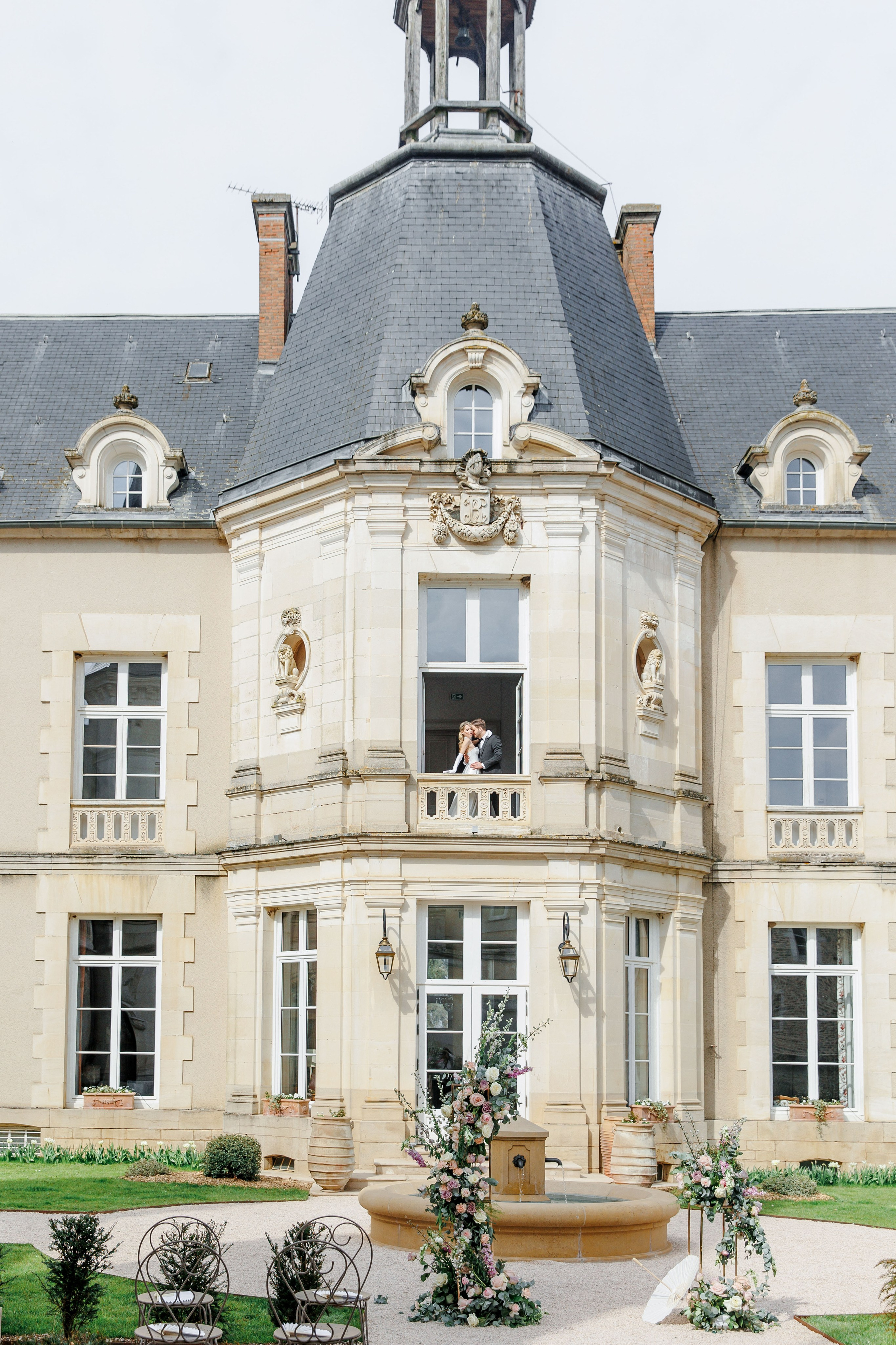 Charming chateau in France featuring vibrant flowers and a serene atmosphere for outdoor ceremonies.