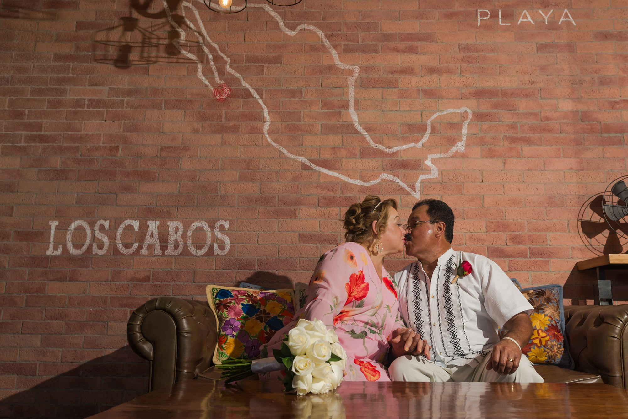 30th wedding anniversary celebration at Hyatt Ziva Los Cabos – couple portrait inside restaurant with Mexico map mural