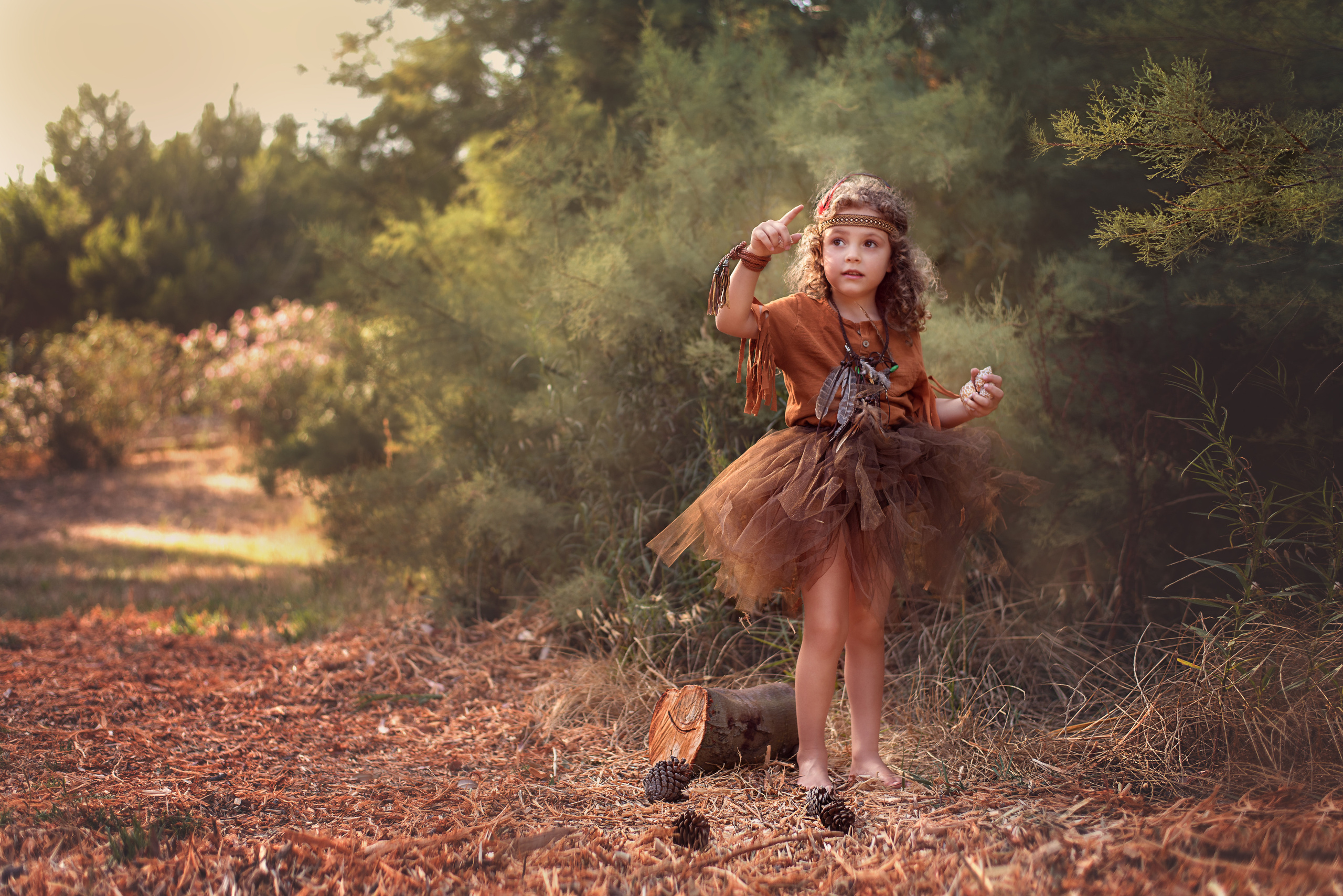girl holding a pine cone