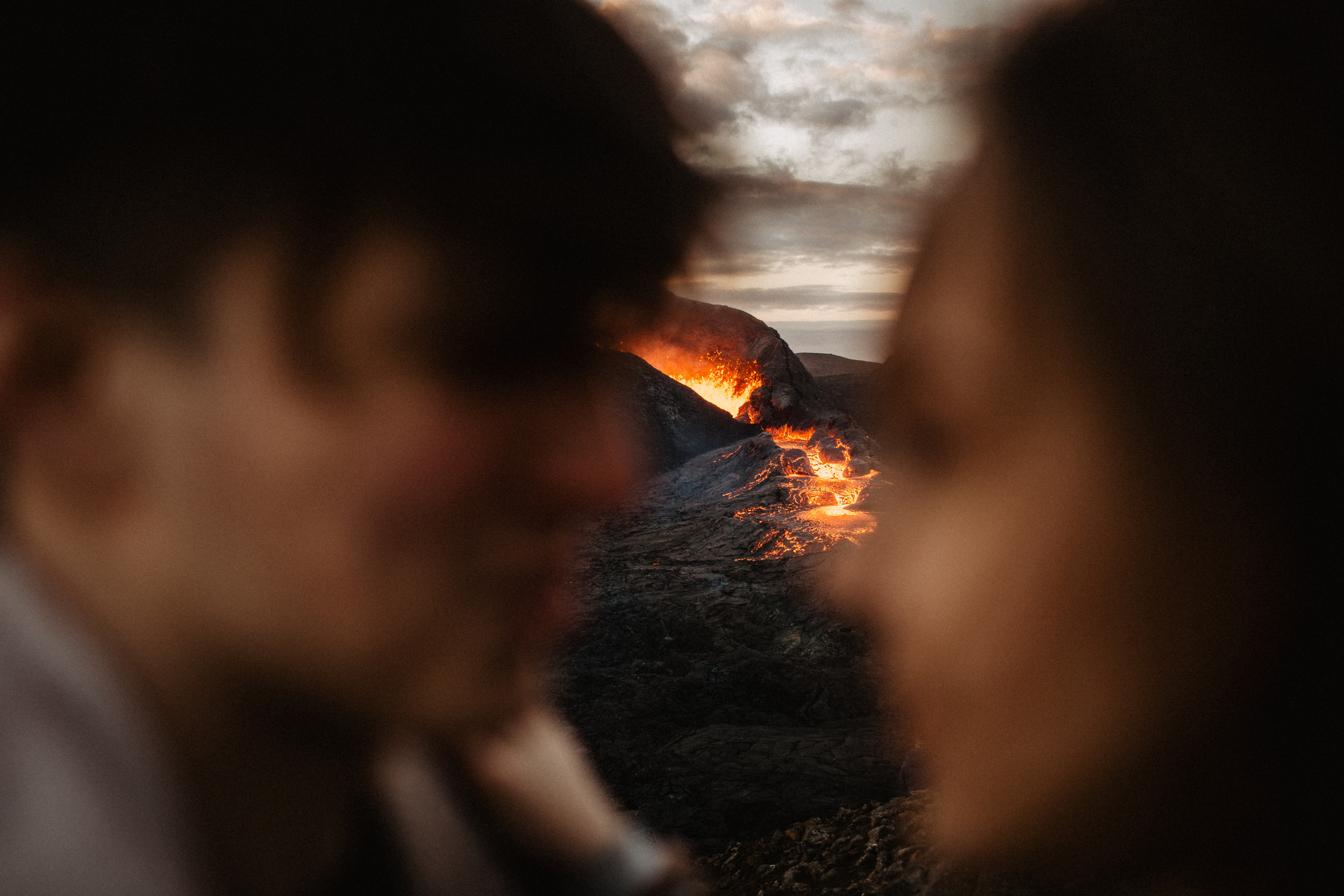 Couple photoshoot in front of volcano eruption in Iceland. Iceland elopement photographer & videographer