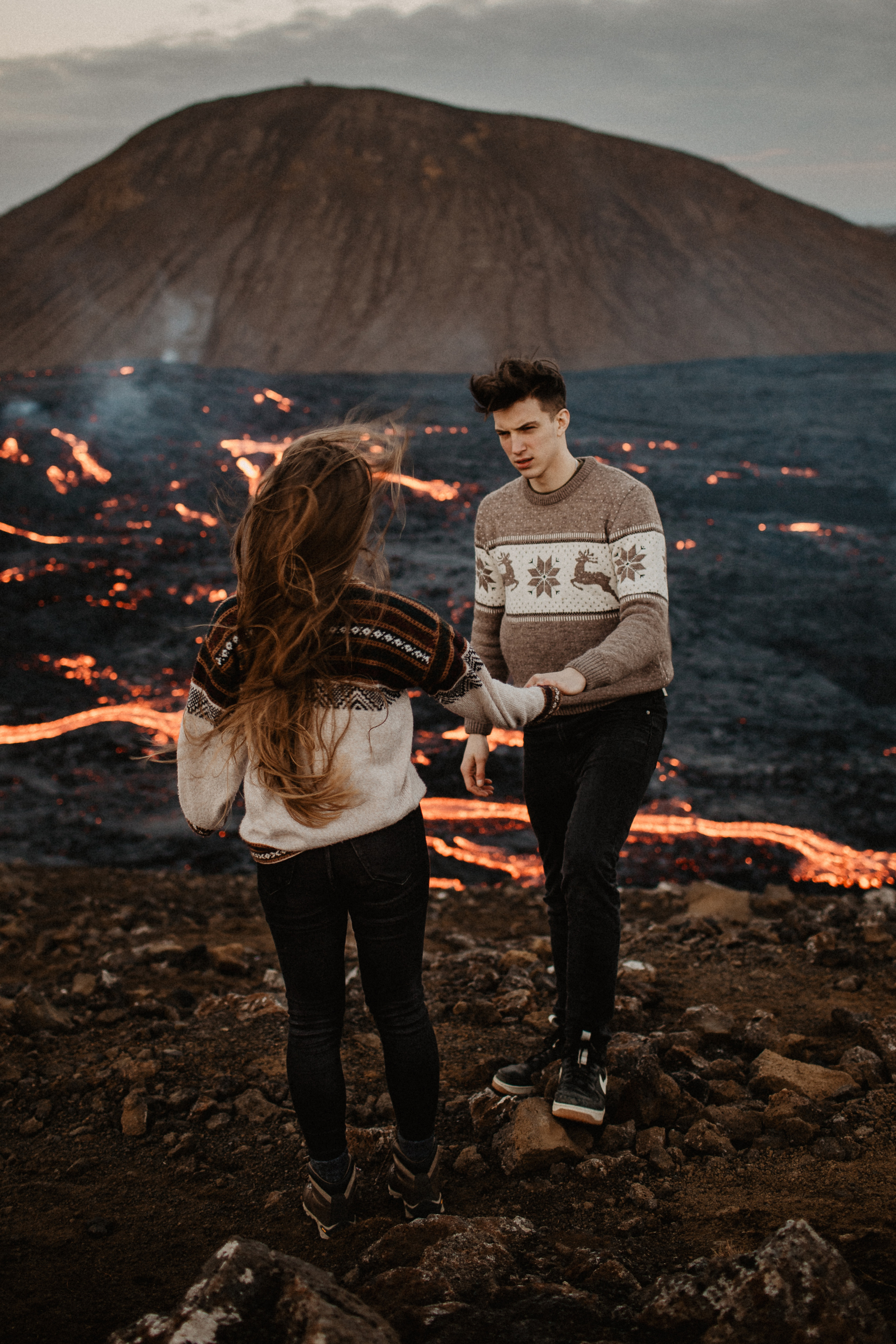 Couple photoshoot in front of volcano eruption in Iceland. Iceland elopement photographer & videographer