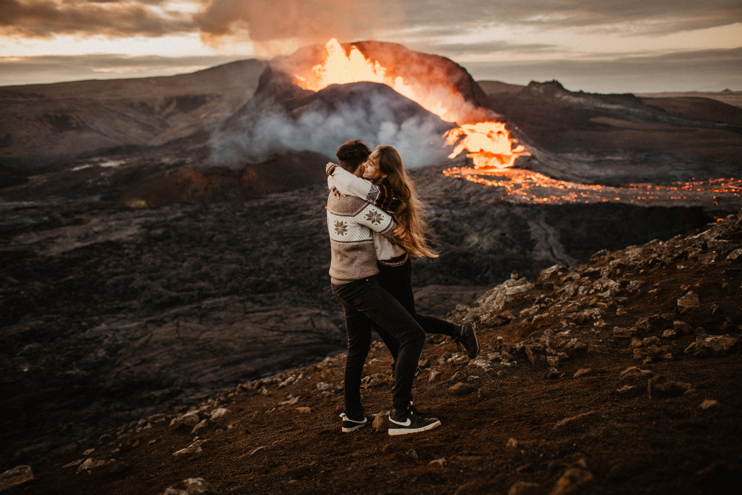 Couple photoshoot in front of volcano eruption in Iceland. Iceland elopement photographer & videographer