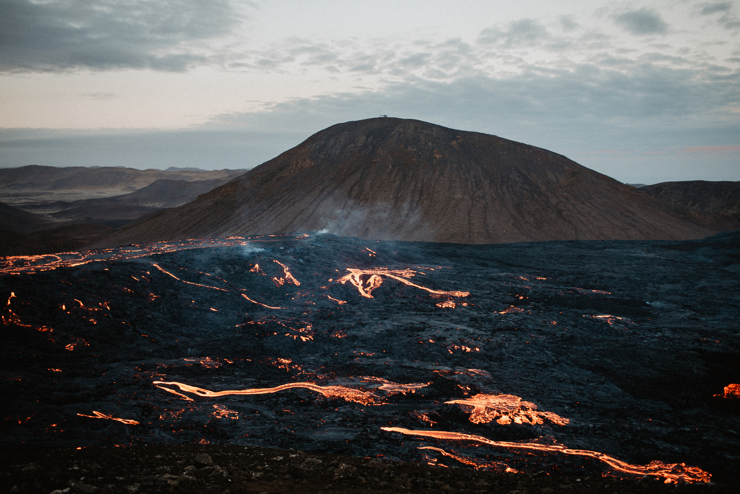 Couple photoshoot in front of volcano eruption in Iceland. Iceland elopement photographer & videographer