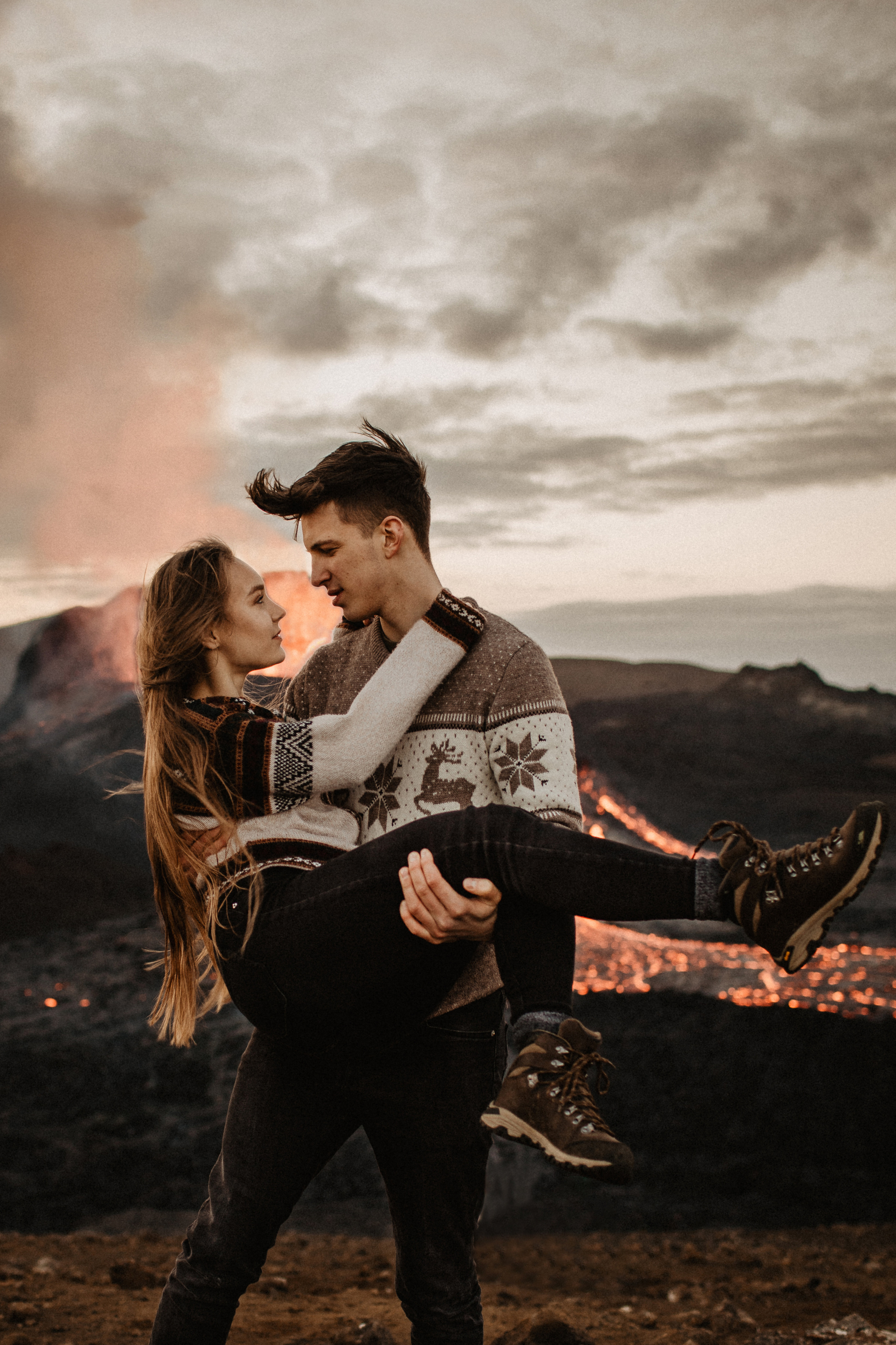 Couple photoshoot in front of volcano eruption in Iceland. Iceland elopement photographer & videographer
