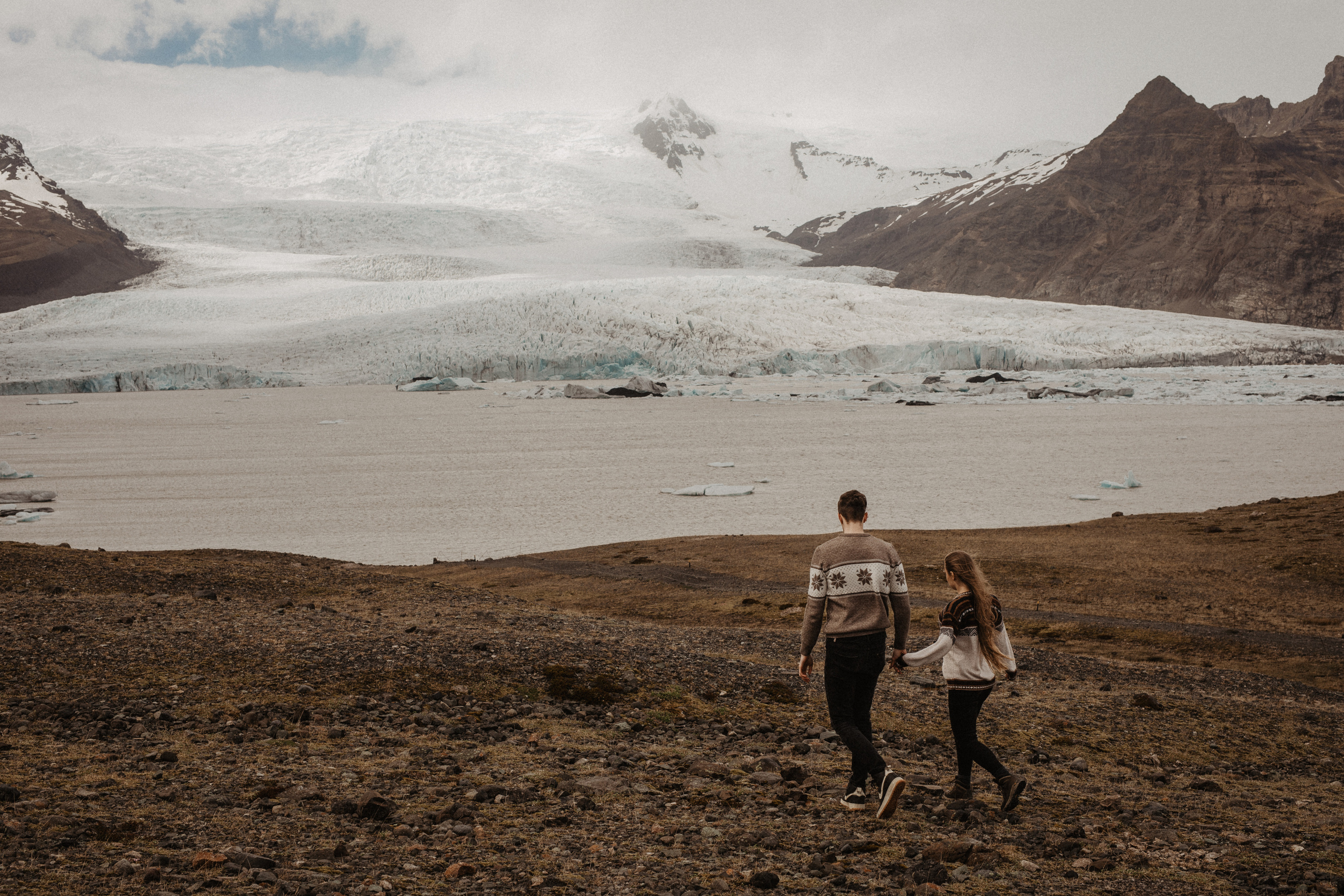 Couple photoshoot in front of volcano eruption in Iceland. Iceland elopement photographer & videographer