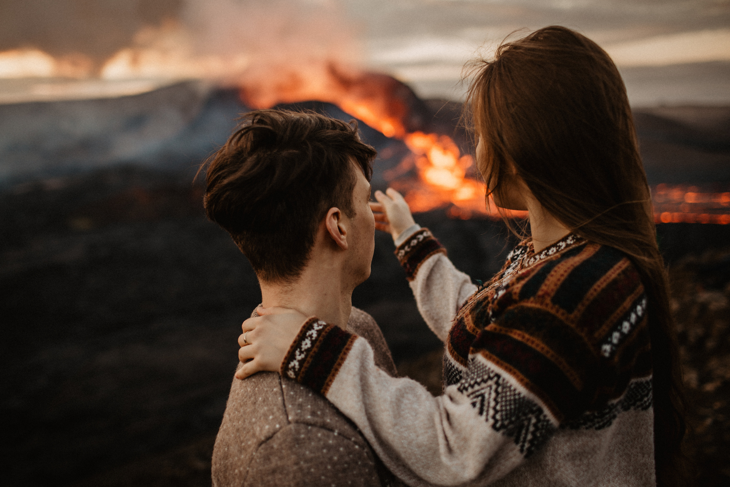 Couple photoshoot in front of volcano eruption in Iceland. Iceland elopement photographer & videographer