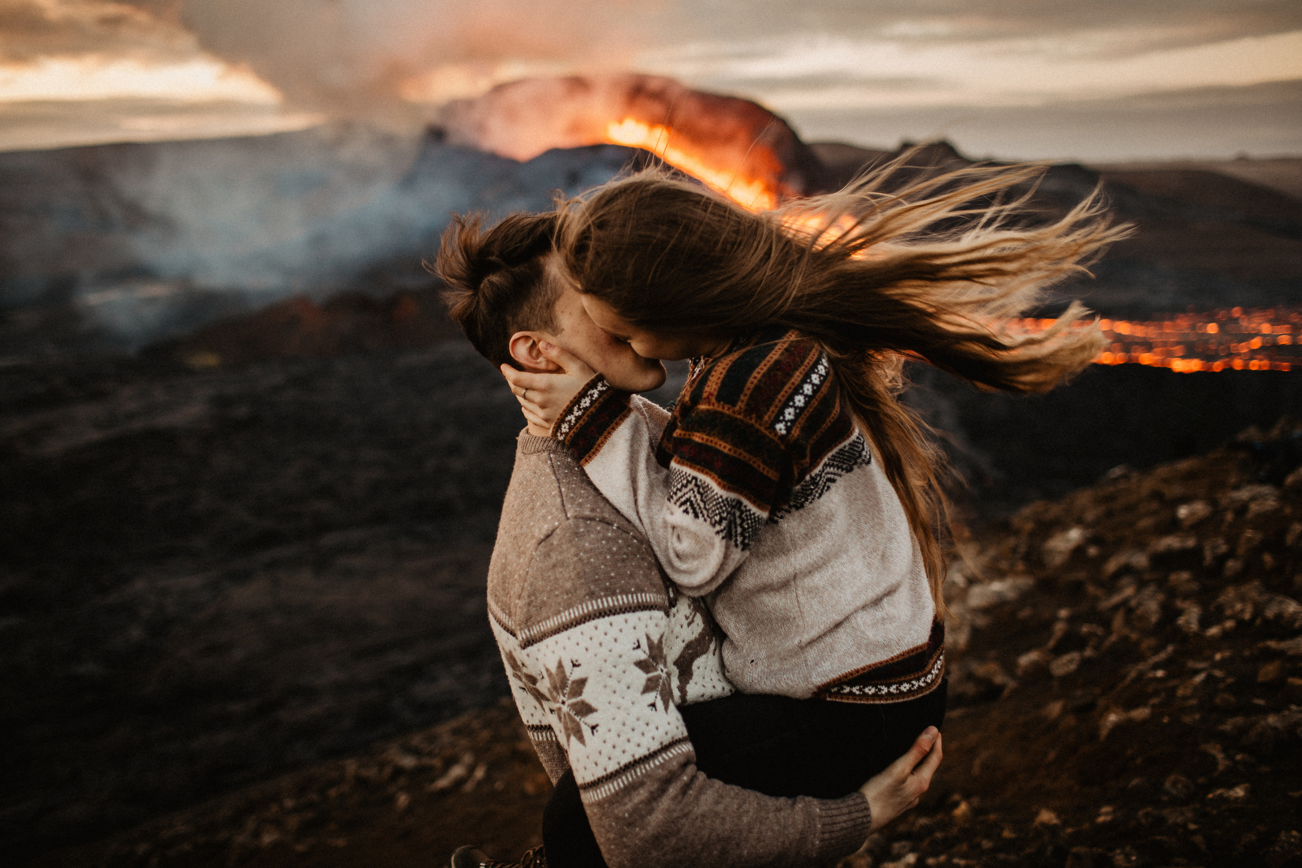 Couple photoshoot in front of volcano eruption in Iceland. Iceland elopement photographer & videographer