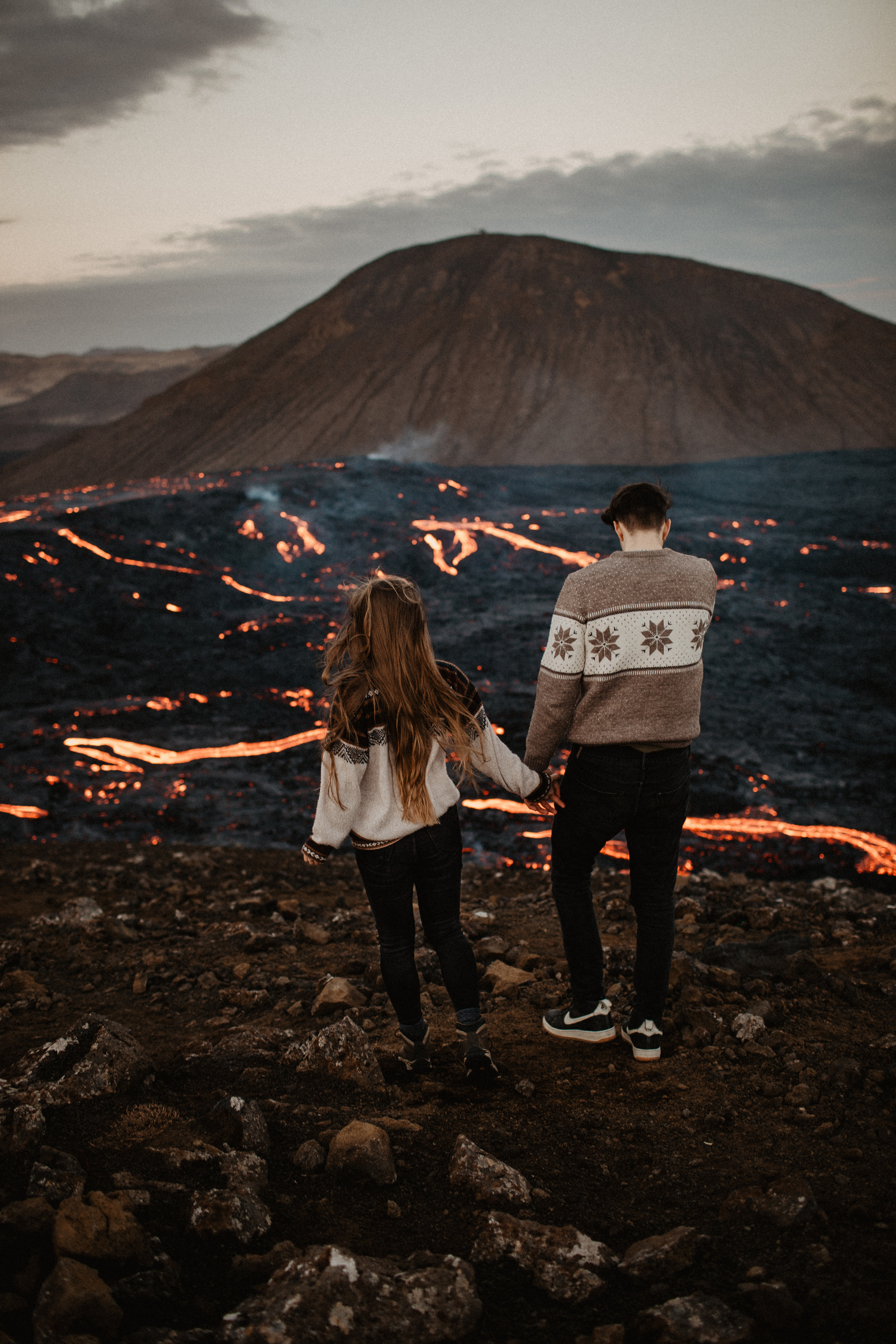 Couple photoshoot in front of volcano eruption in Iceland. Iceland elopement photographer & videographer