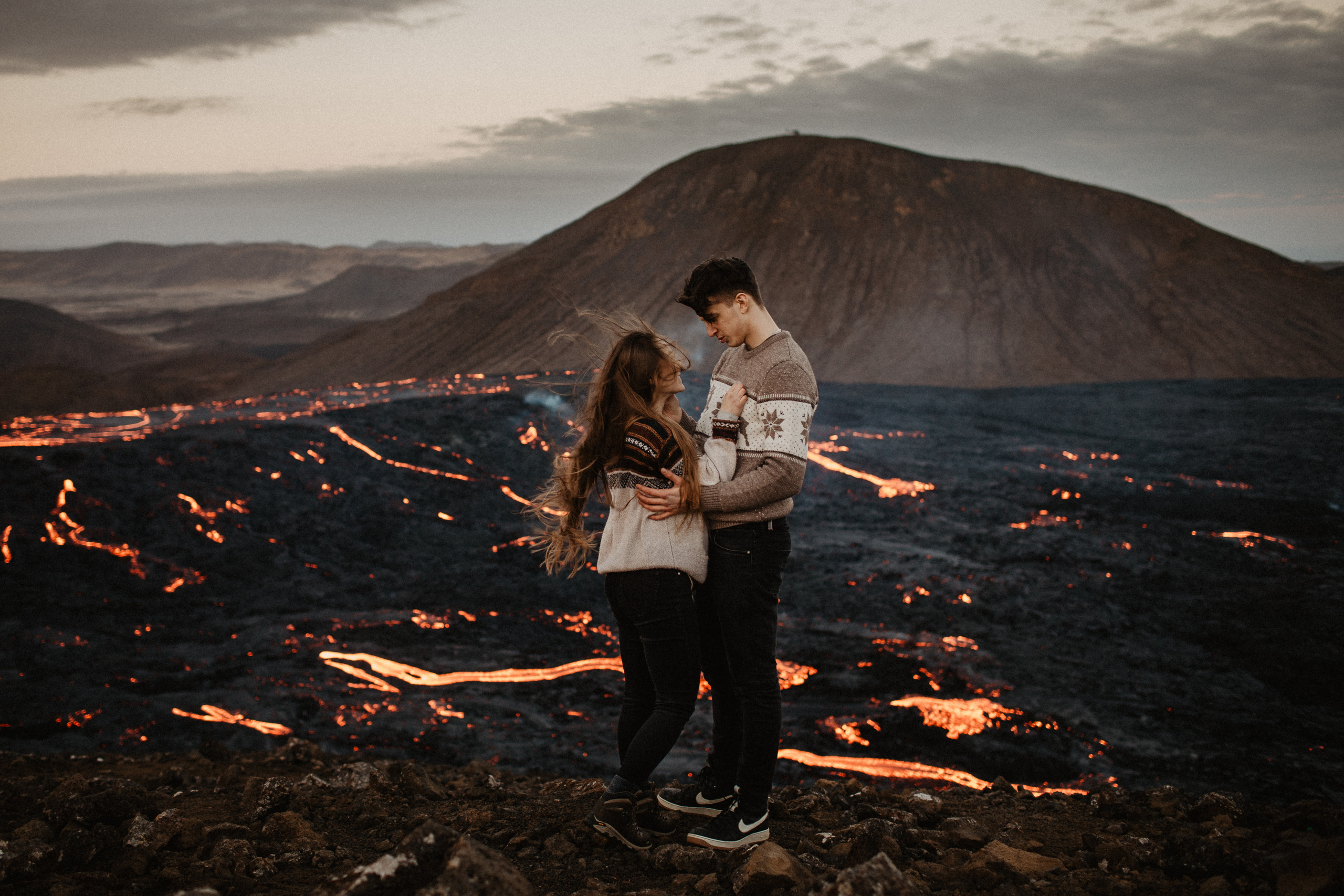 Couple photoshoot in front of volcano eruption in Iceland. Iceland elopement photographer & videographer