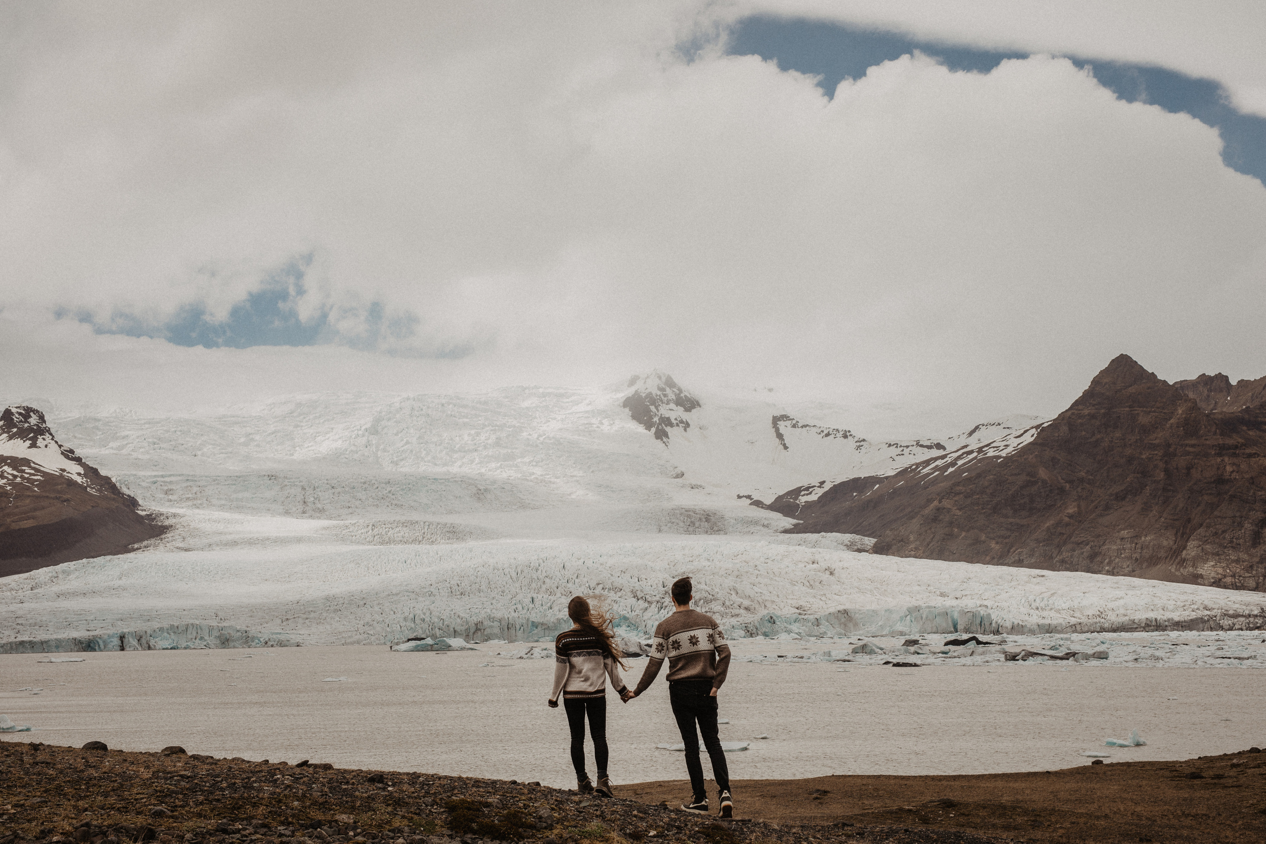Couple photoshoot in front of volcano eruption in Iceland. Iceland elopement photographer & videographer