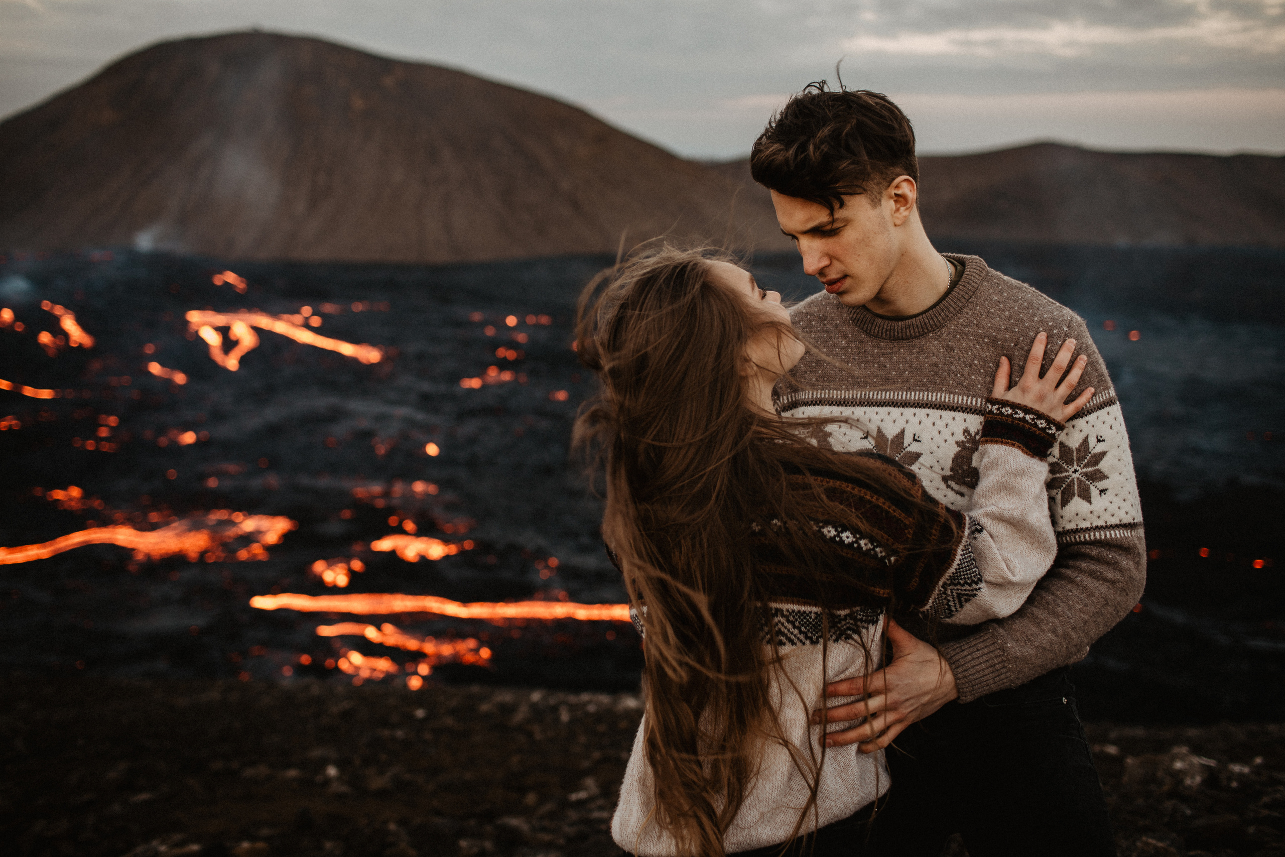 Couple photoshoot in front of volcano eruption in Iceland. Iceland elopement photographer & videographer