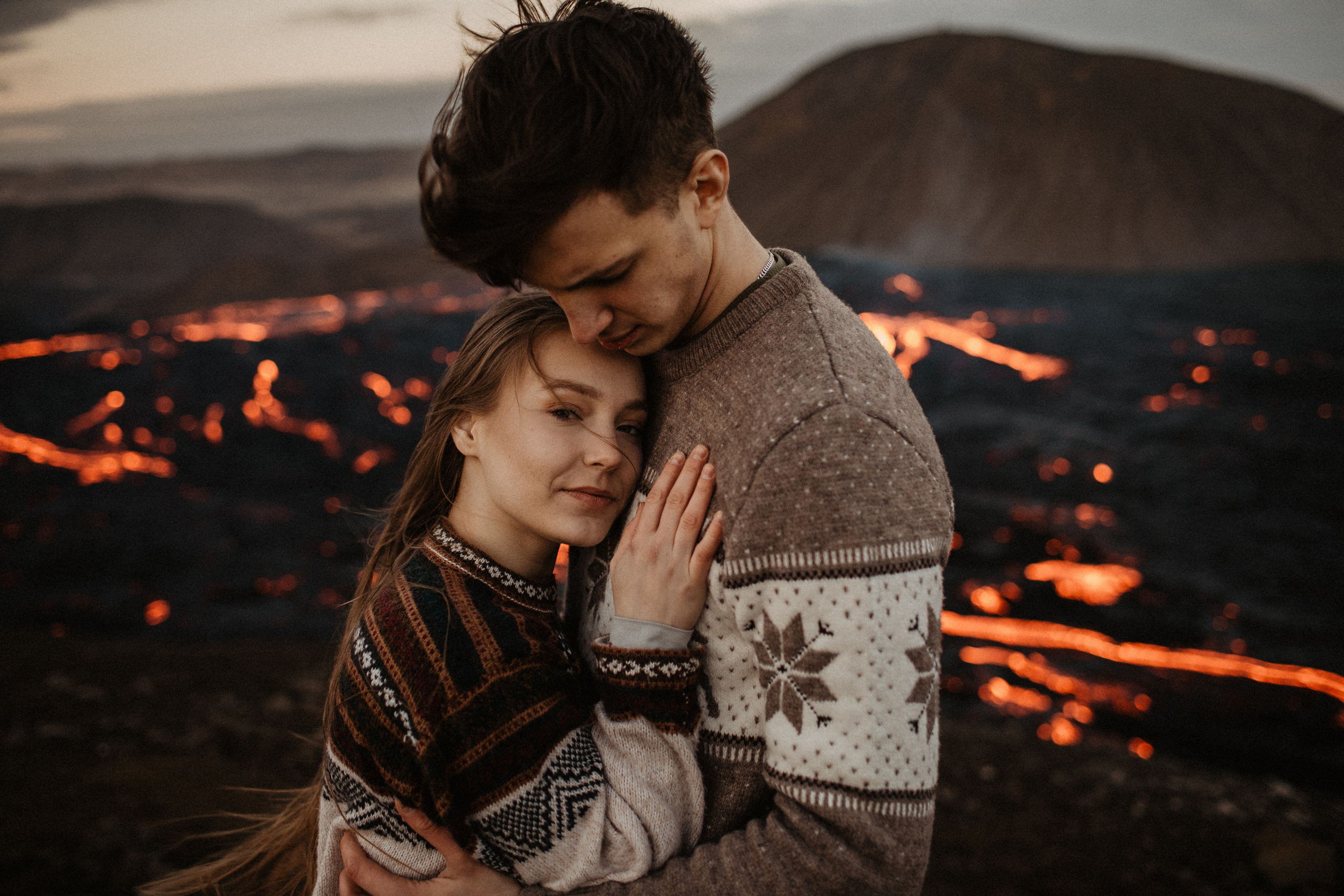 Couple photoshoot in front of volcano eruption in Iceland. Iceland elopement photographer & videographer