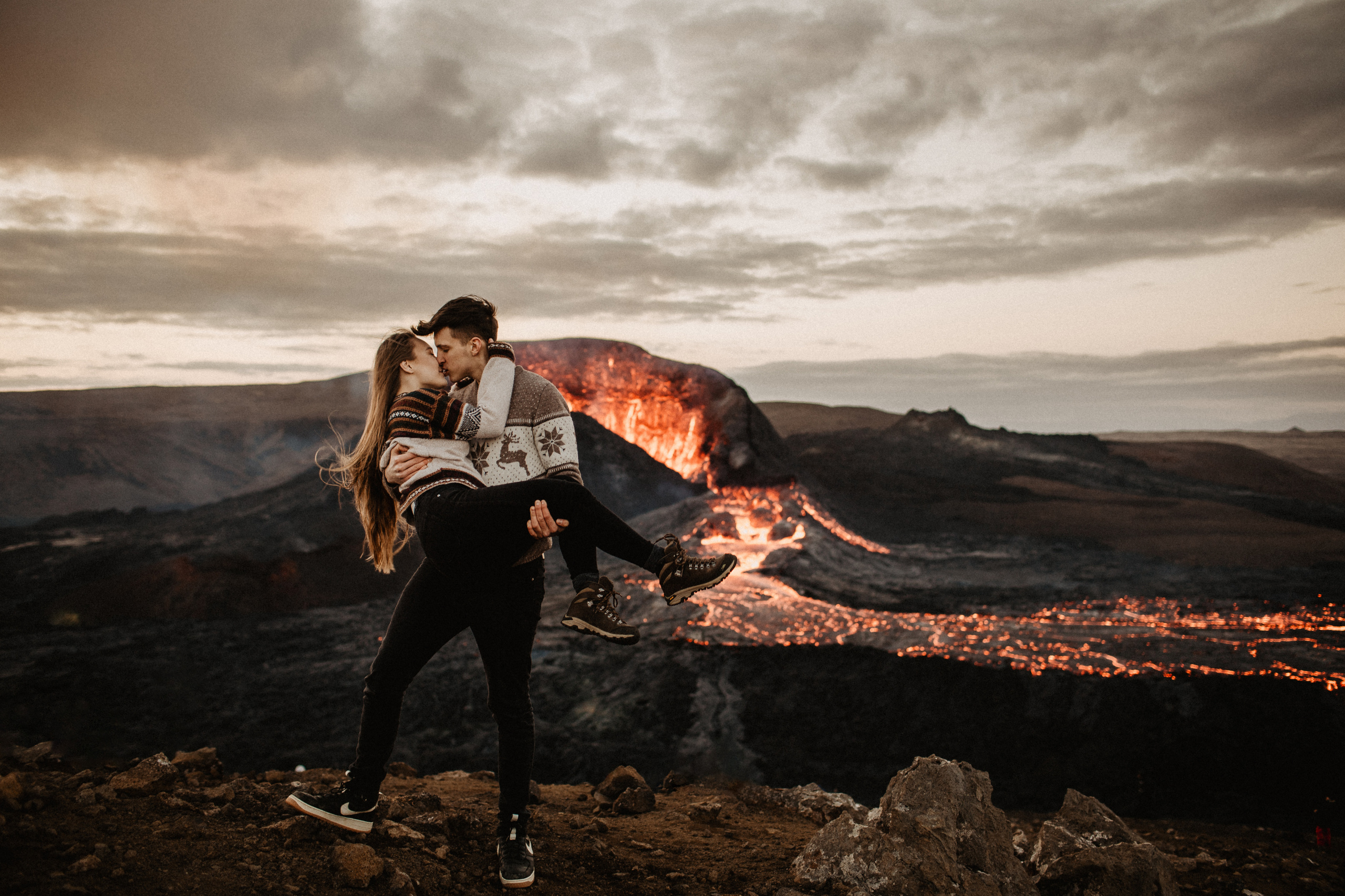 Couple photoshoot in front of volcano eruption in Iceland. Iceland elopement photographer & videographer