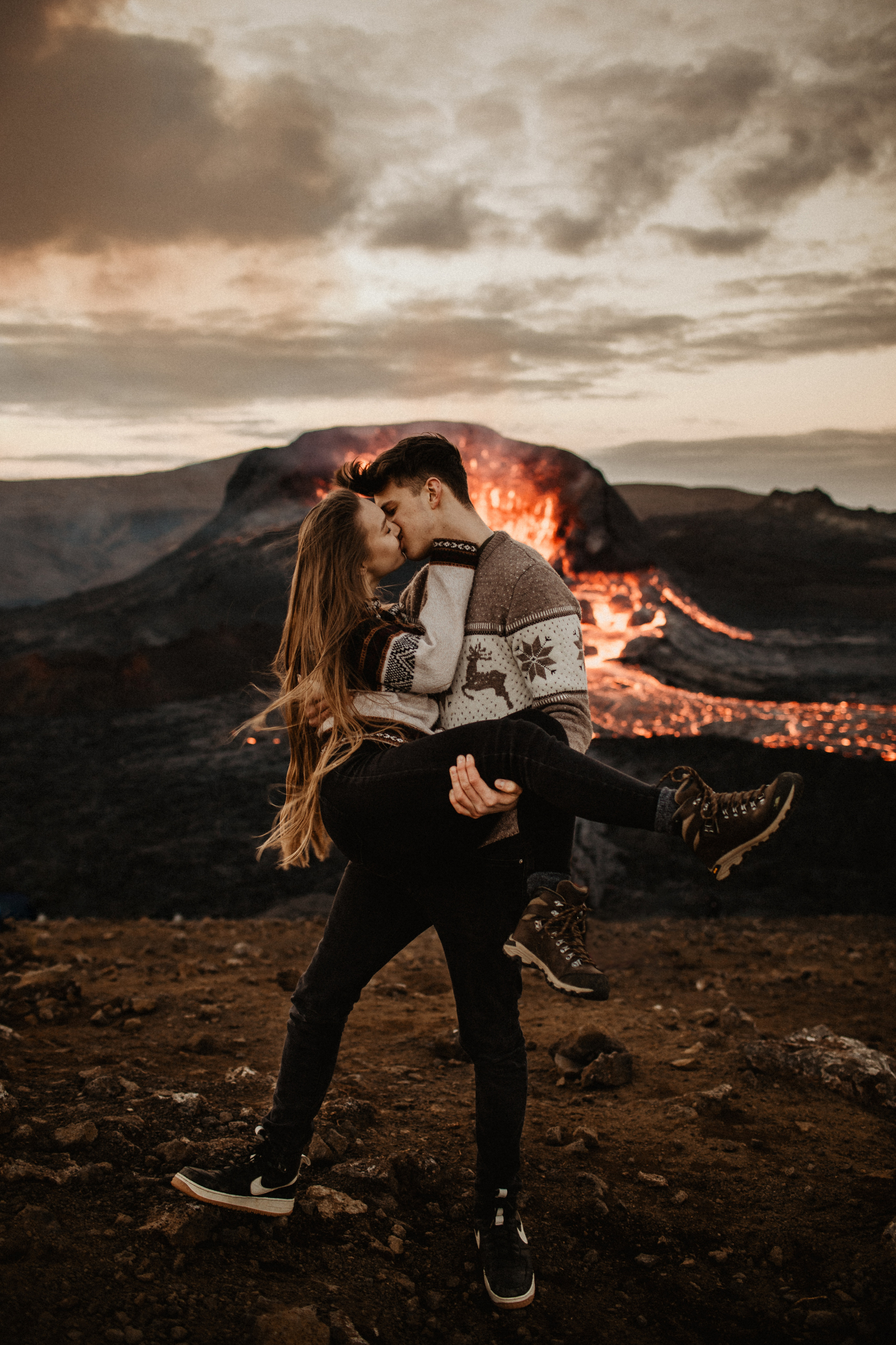 Couple photoshoot in front of volcano eruption in Iceland. Iceland elopement photographer & videographer