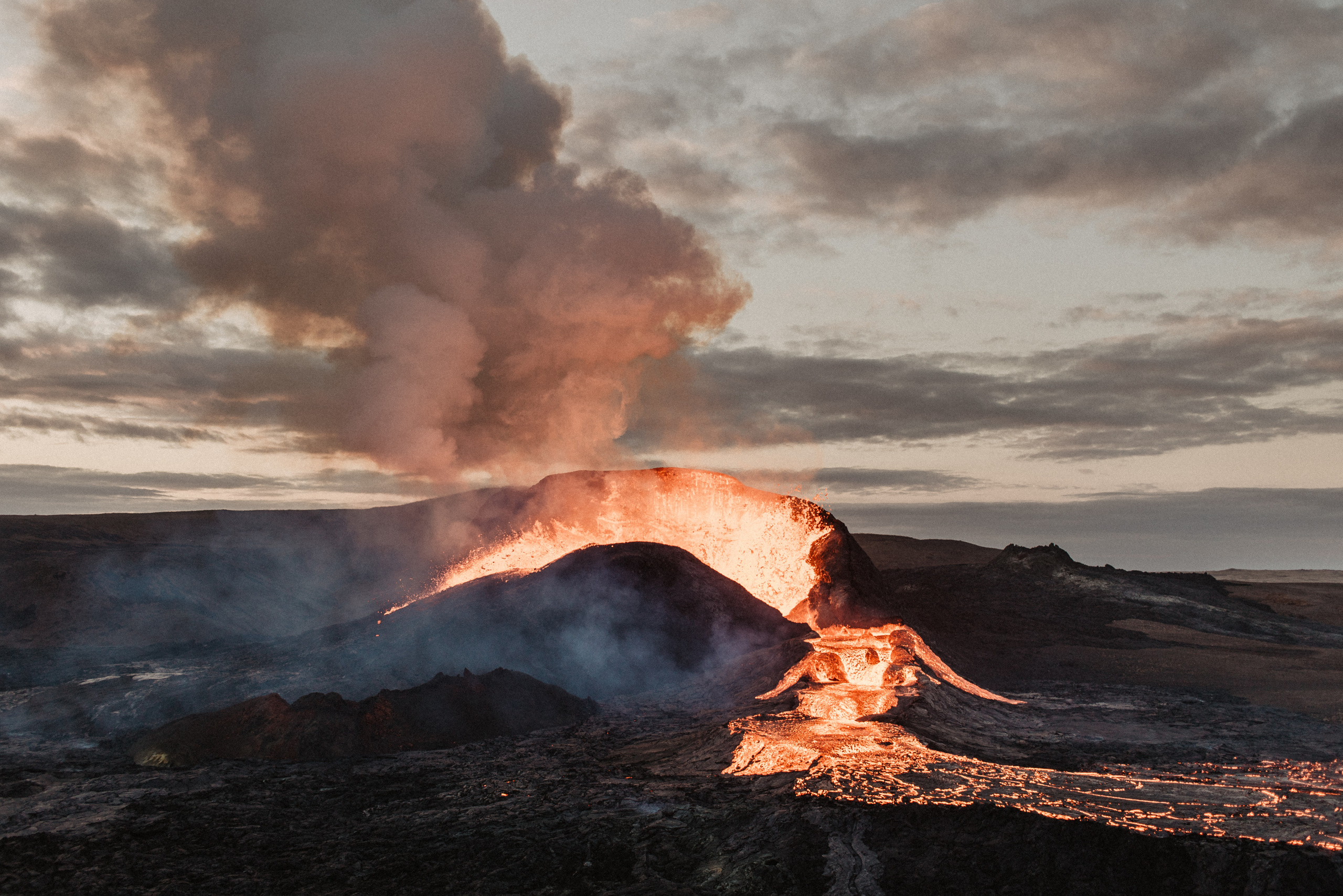 Couple photoshoot in front of volcano eruption in Iceland. Iceland elopement photographer & videographer