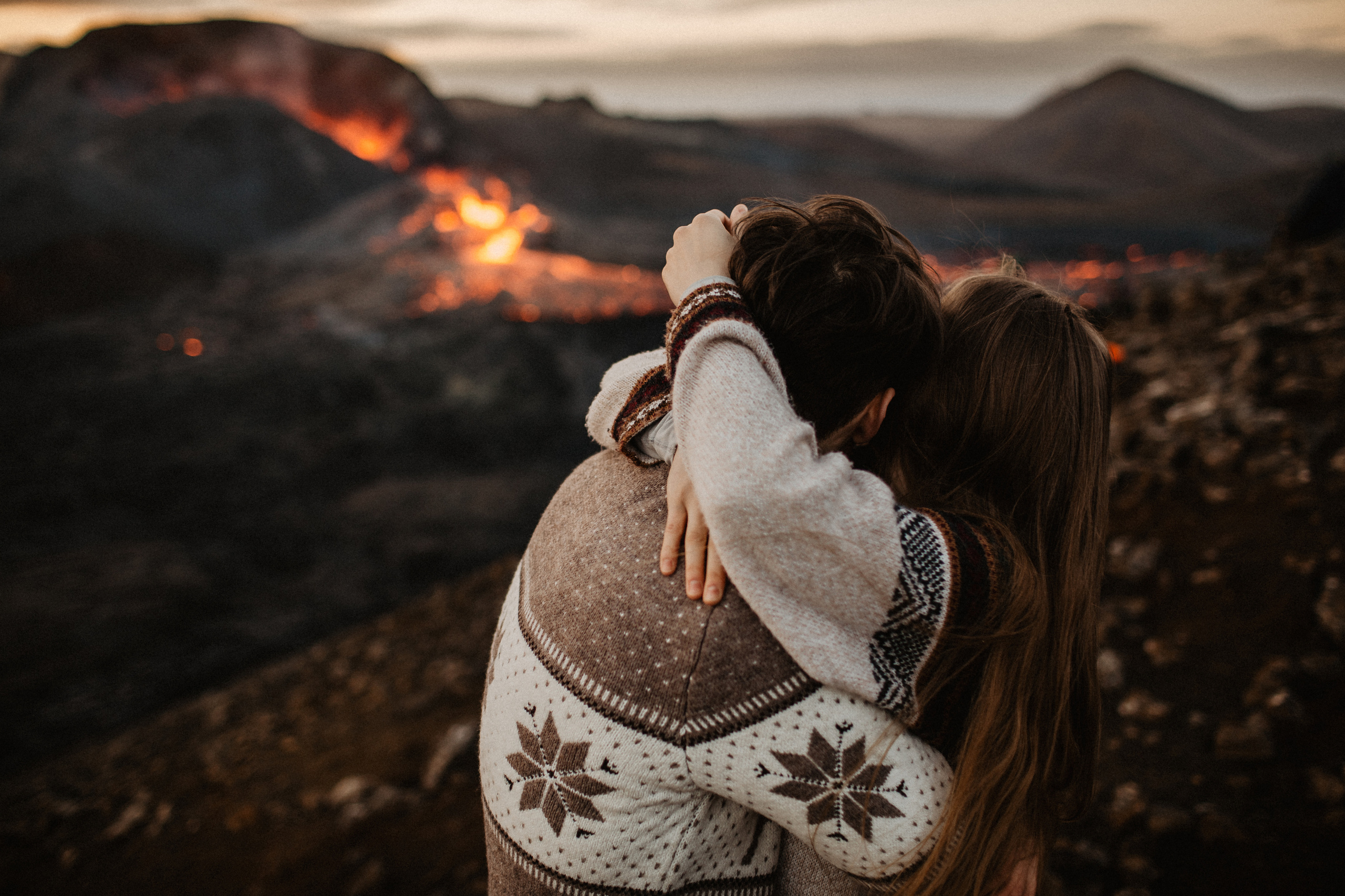 Couple photoshoot in front of volcano eruption in Iceland. Iceland elopement photographer & videographer