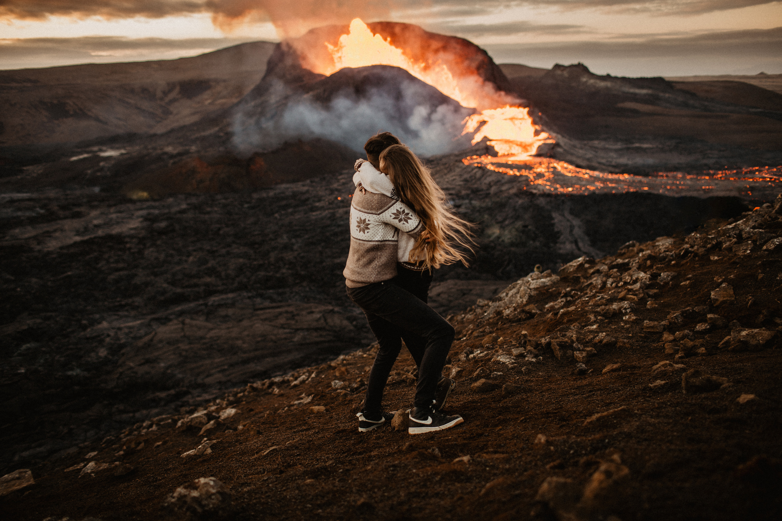 Couple photoshoot in front of volcano eruption in Iceland. Iceland elopement photographer & videographer