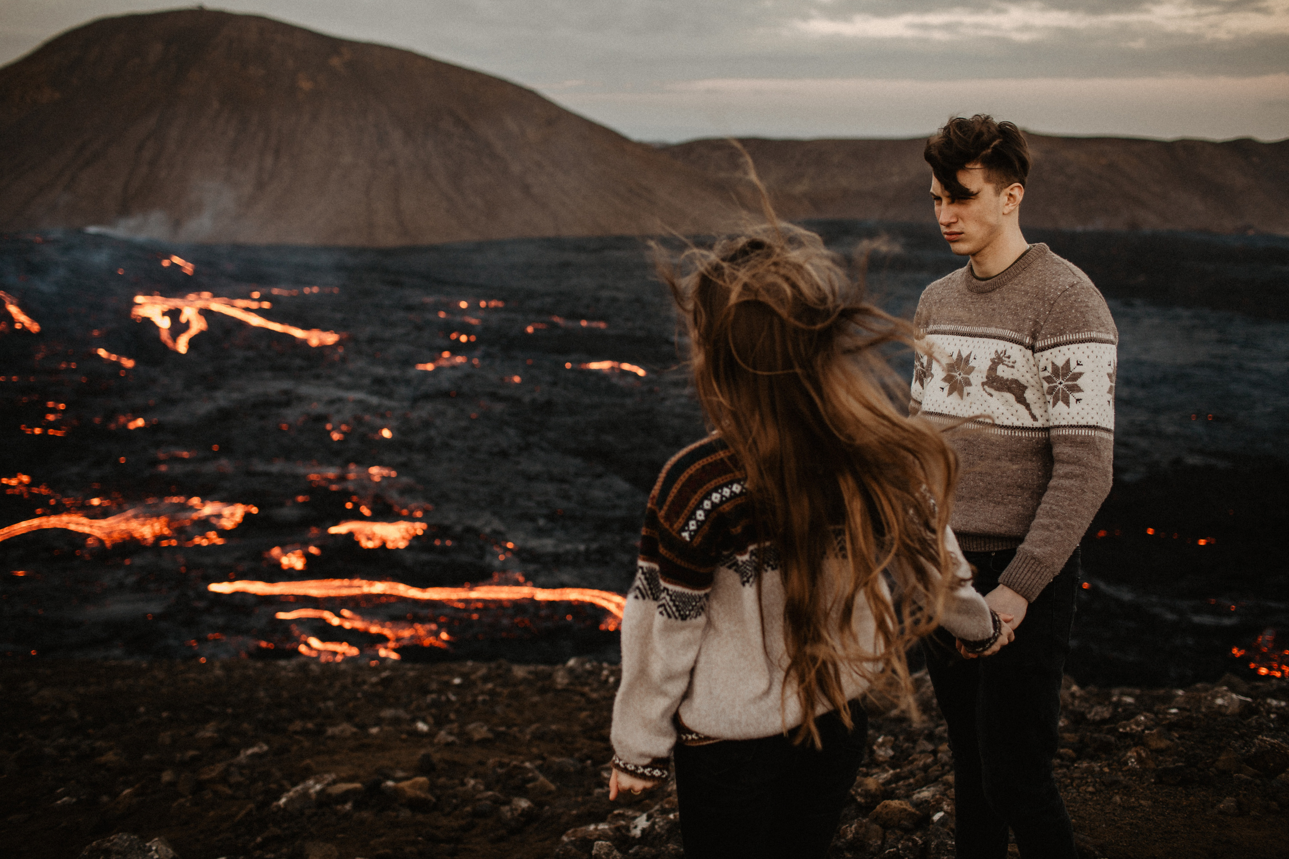 Couple photoshoot in front of volcano eruption in Iceland. Iceland elopement photographer & videographer