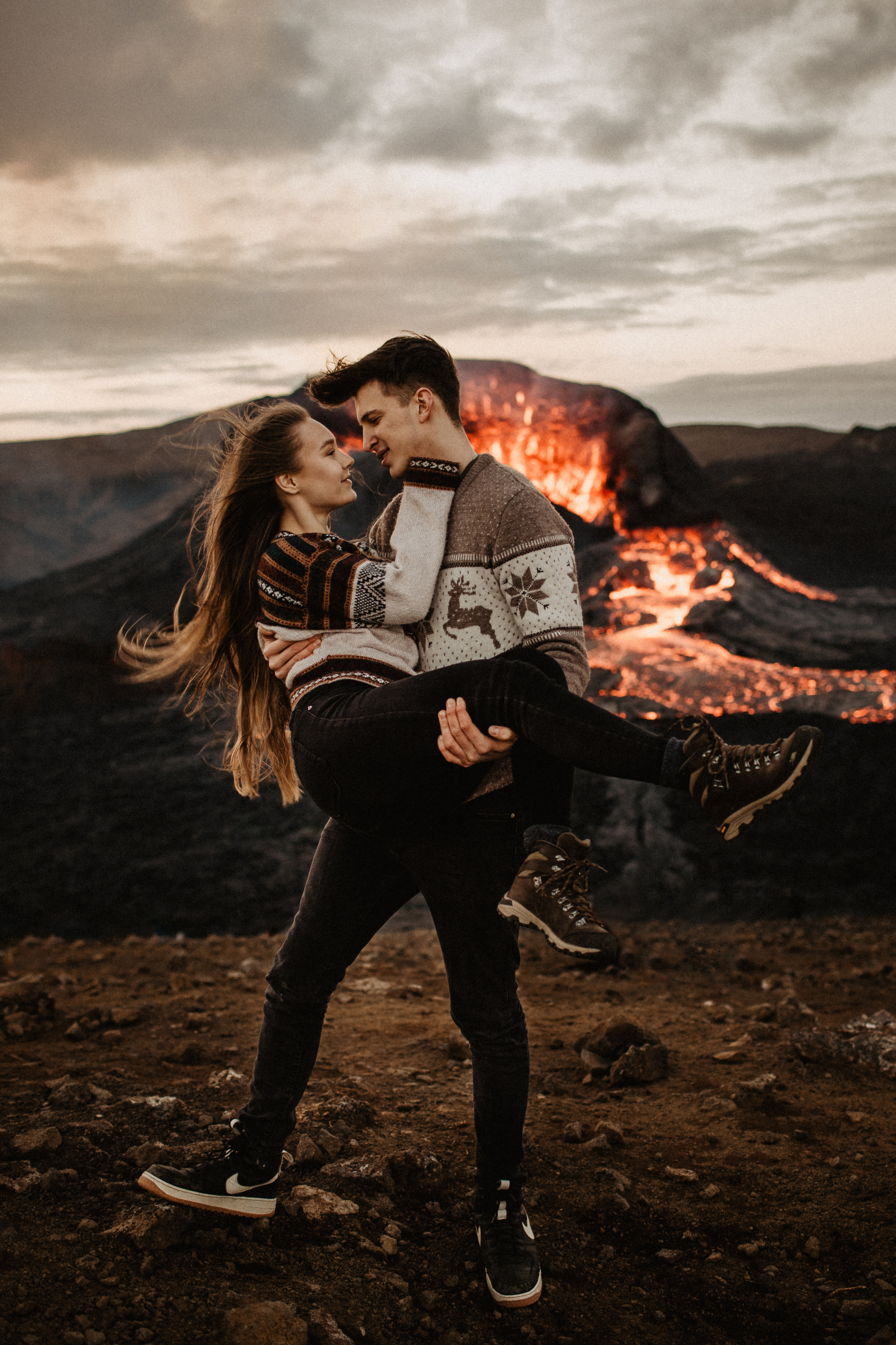 Couple photoshoot in front of volcano eruption in Iceland. Iceland elopement photographer & videographer
