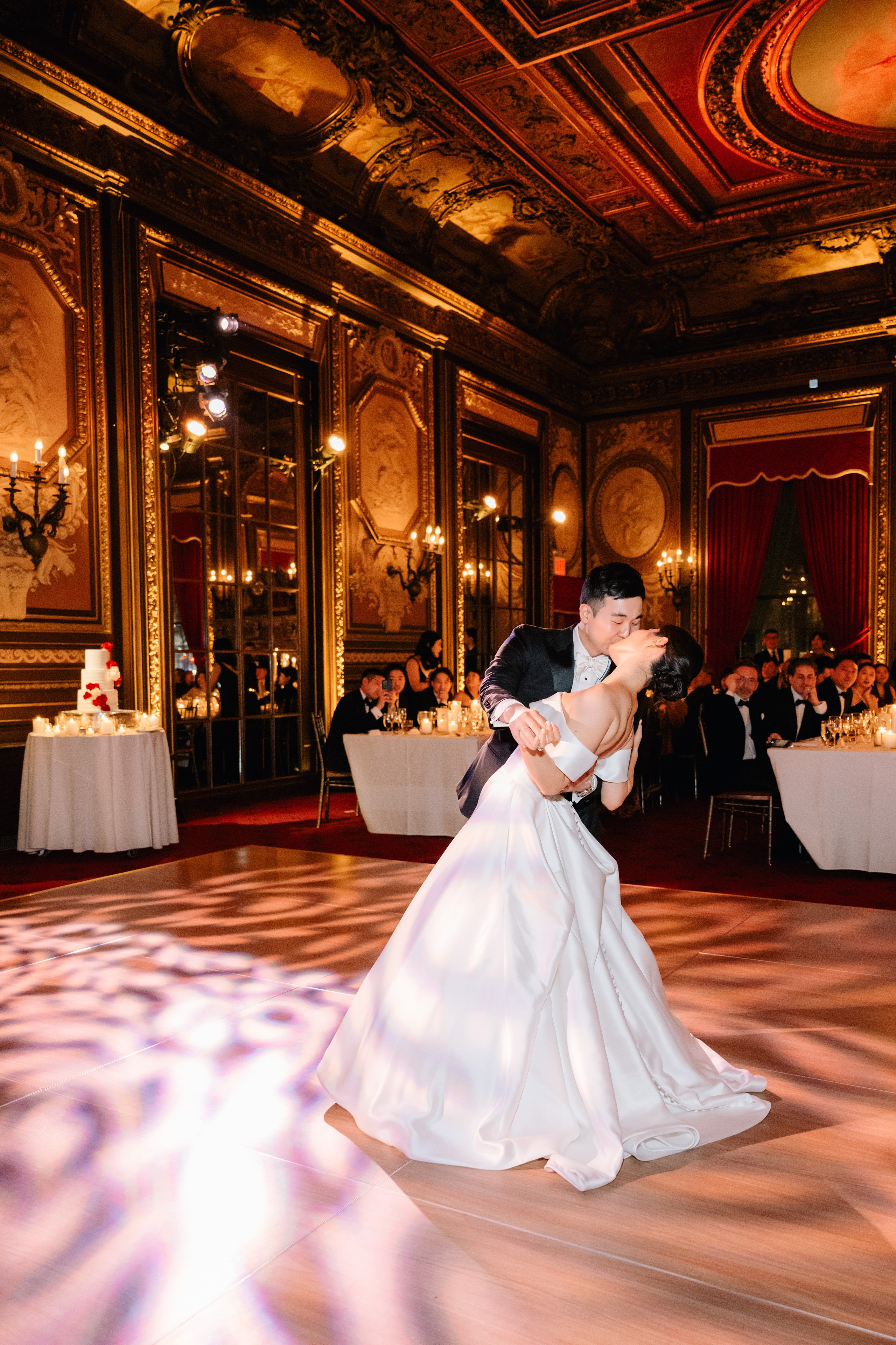a bride and groom dance on the dance floor