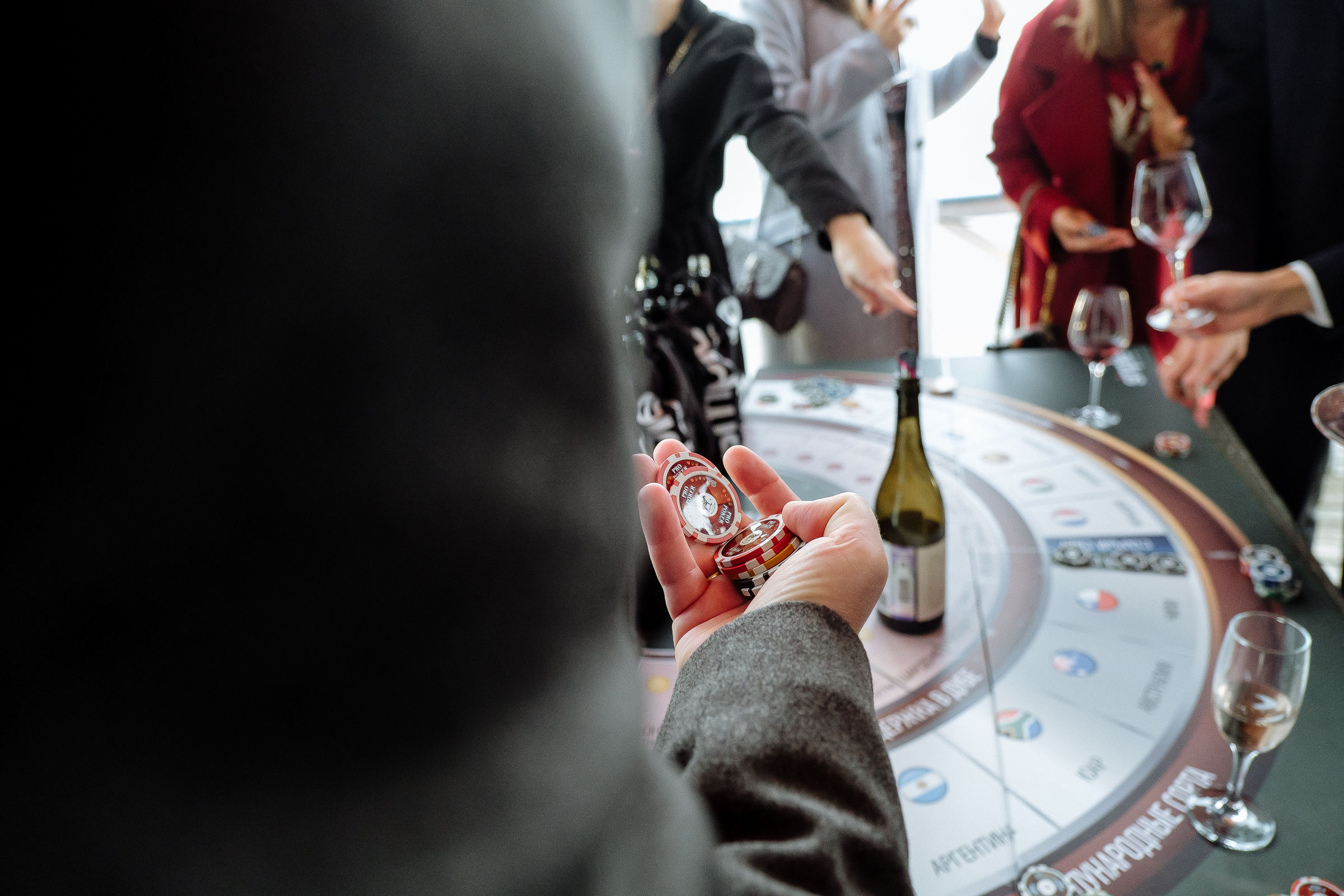 Guests at roulette table, by Tanya Bodgan, Cornwall wedding photographer.  