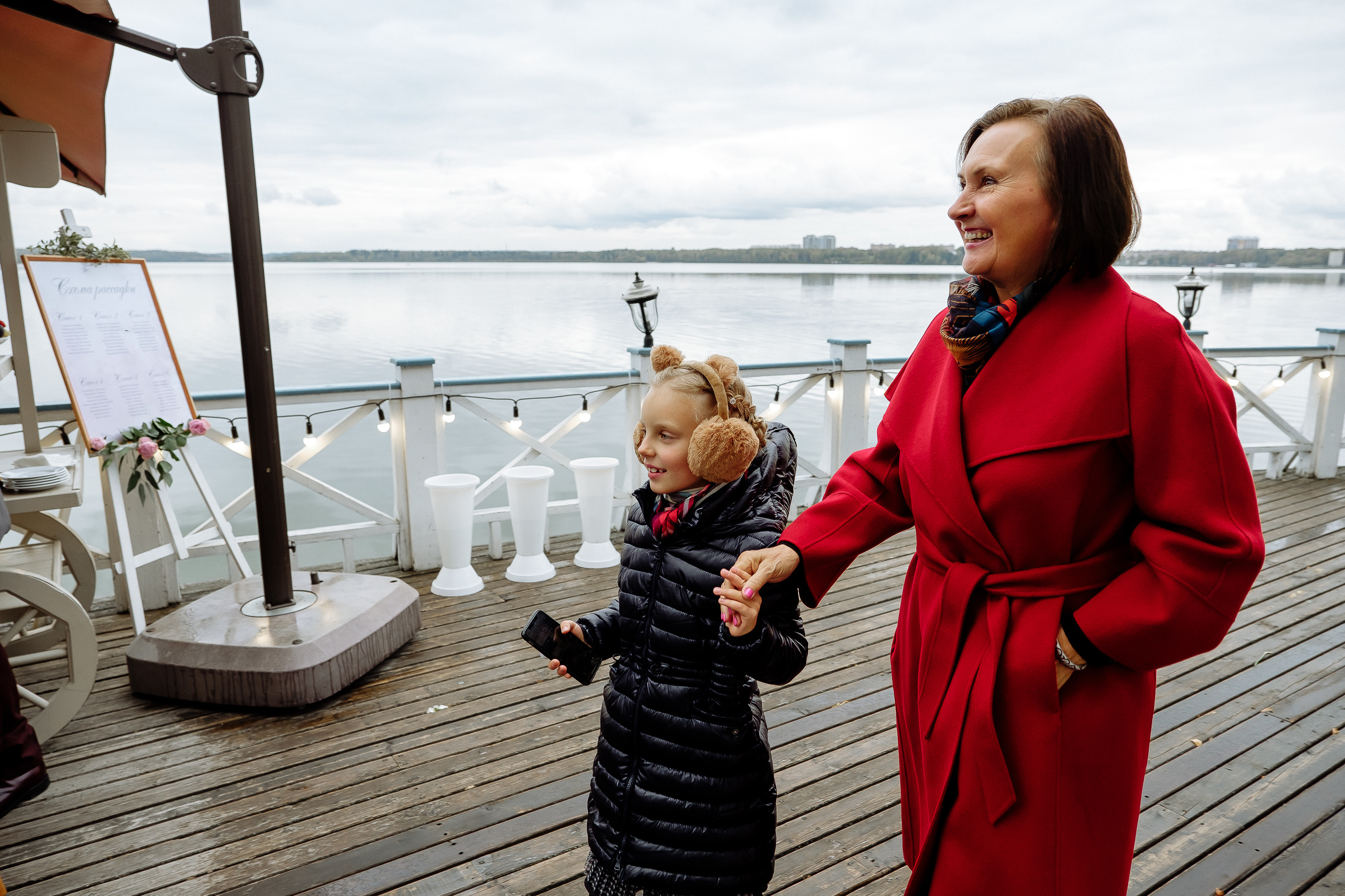 Guests on riverboat with river backdrop, by Tanya Bodgan, Bude wedding photography.  