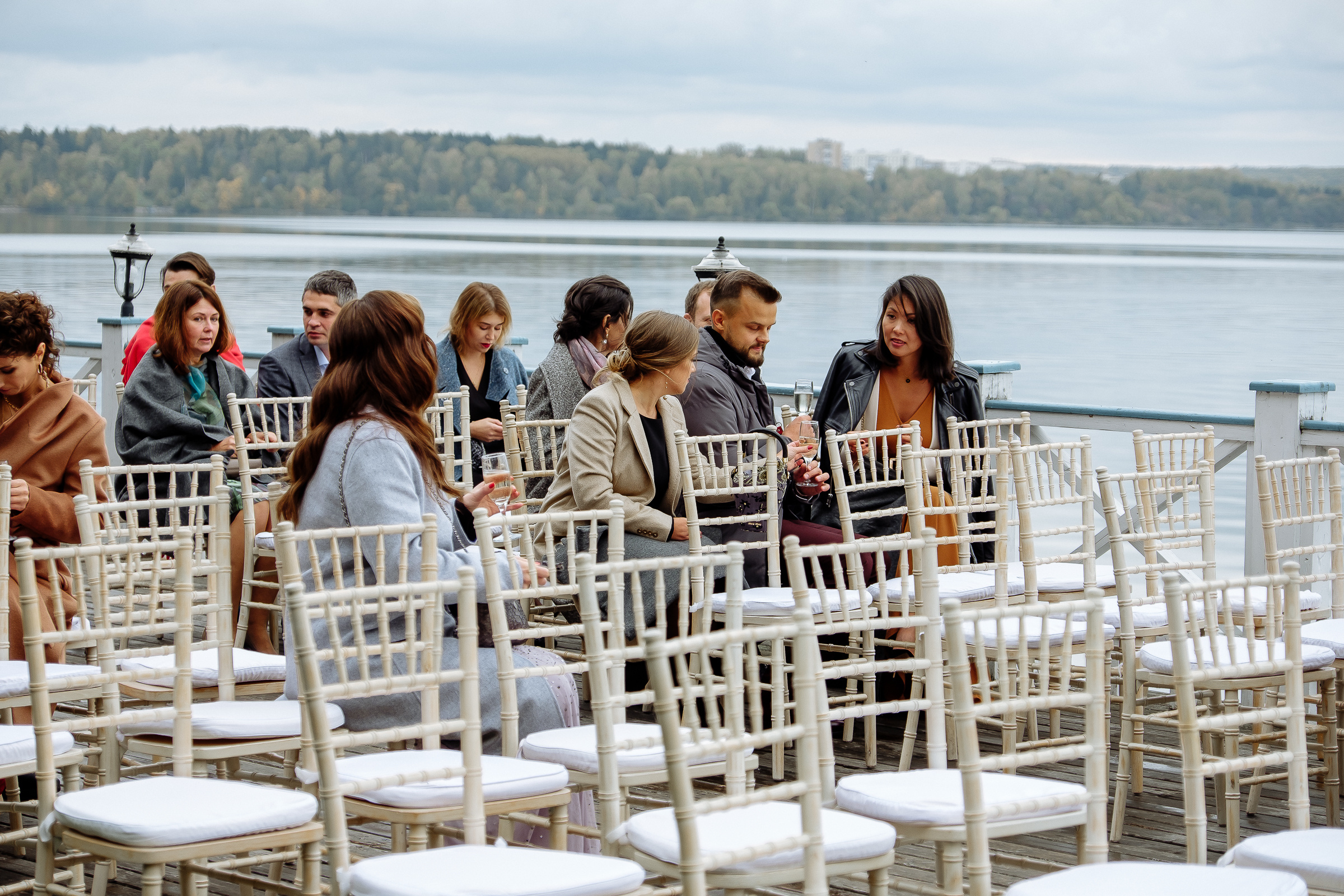Guests sitting on riverboat deck, by Tanya Bodgan, Bude, Cornwall wedding photographer.  