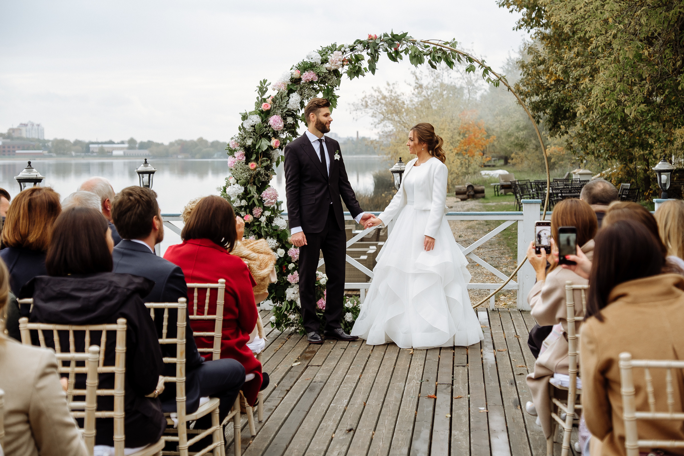 Couple holding hands at ceremony, by Tanya Bodgan, Bude wedding photography.