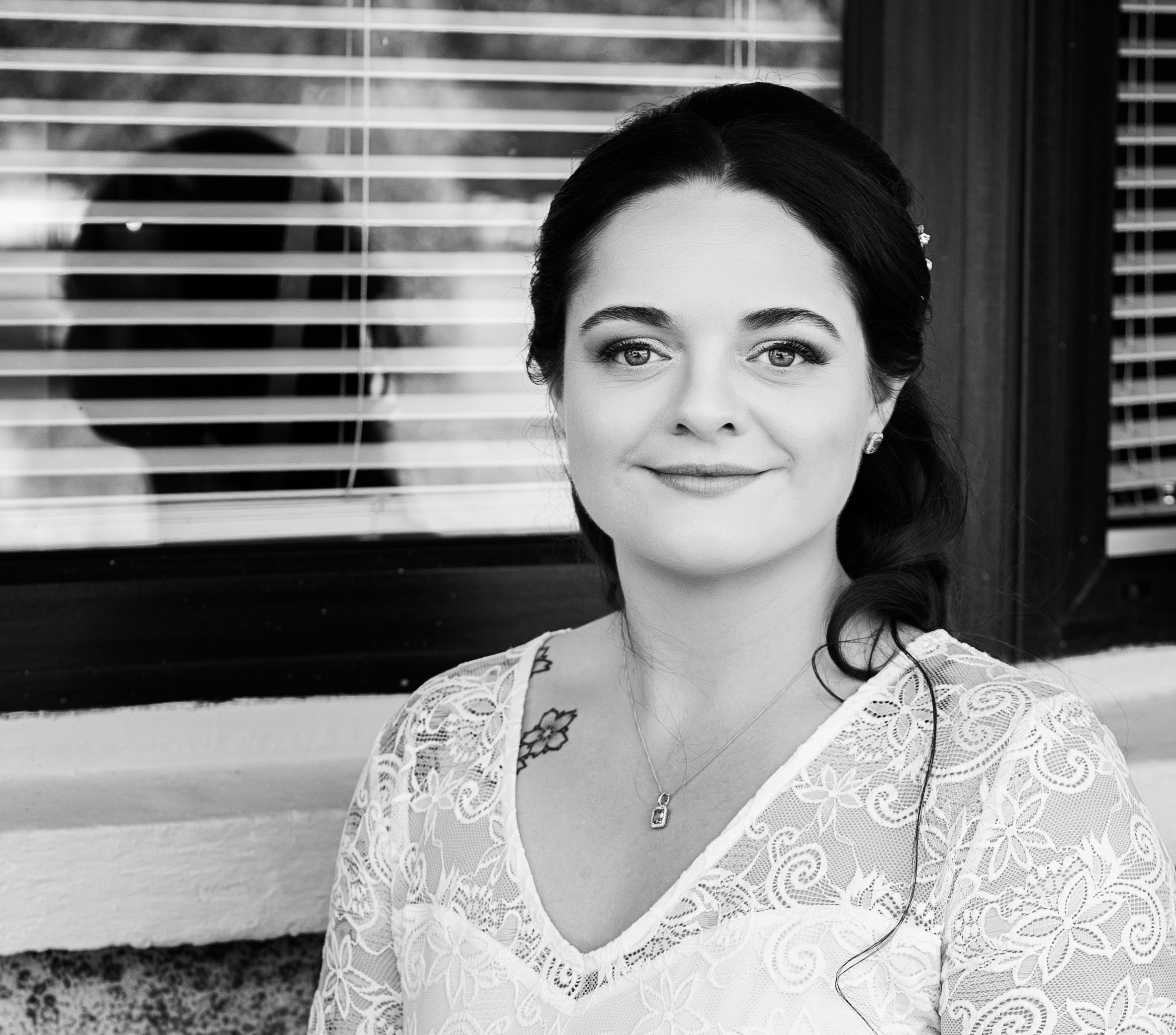 Classic black and white portrait of a smiling bride looking directly at the camera. Professional wedding photography services in County Cork.