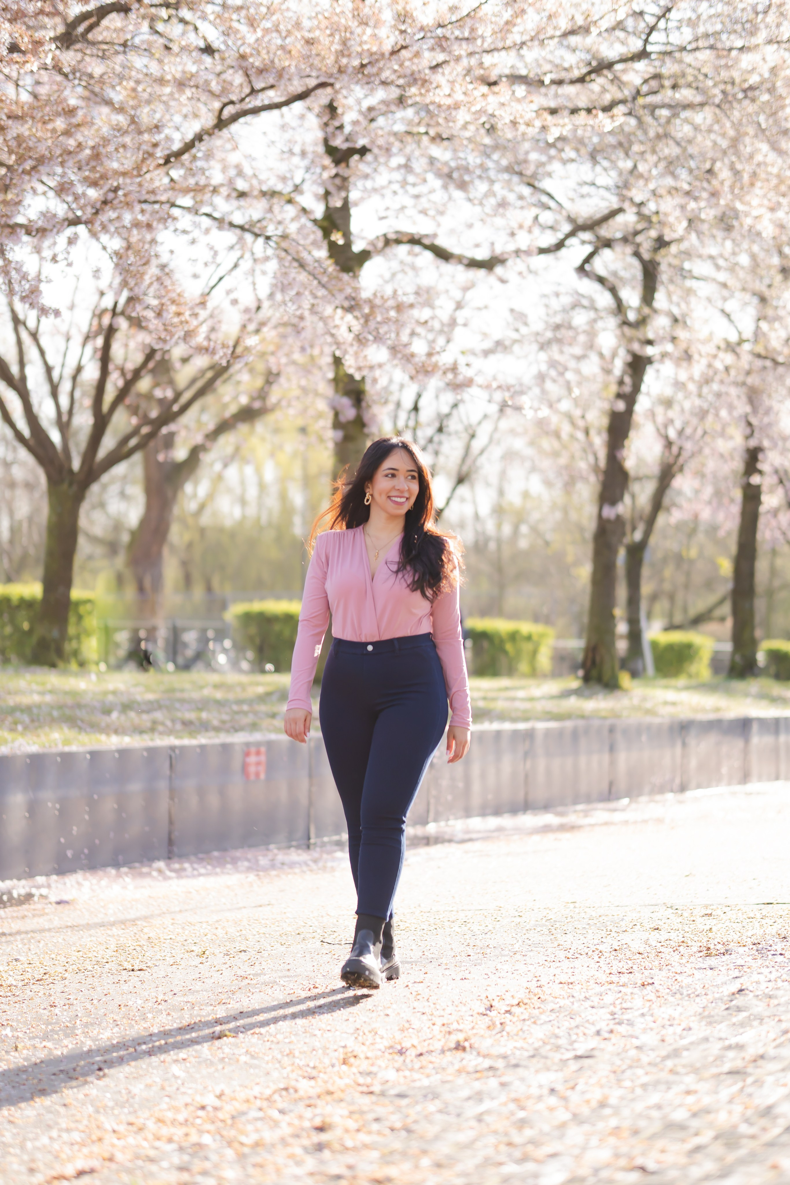 girl walking in a cherry blossoms garden in Netherlands