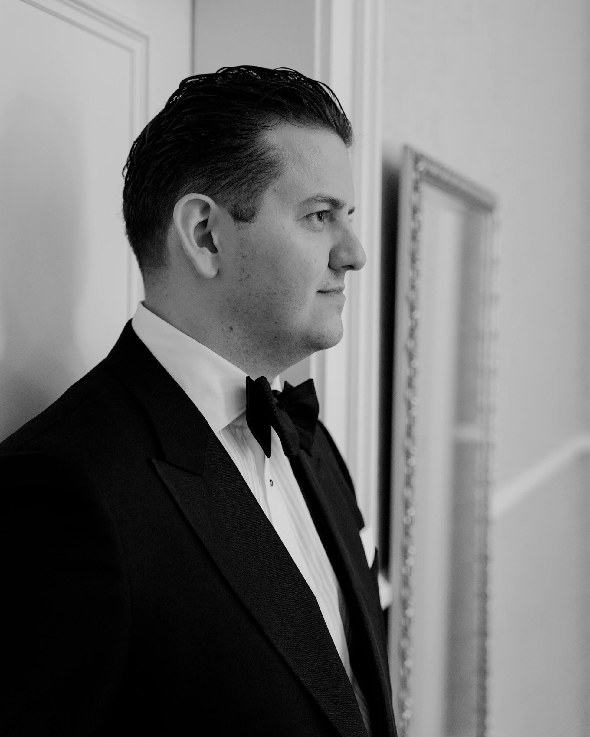 Groom profile portrait in black bow tie, luxury wedding photographer Frankfurt Villa Rothschild