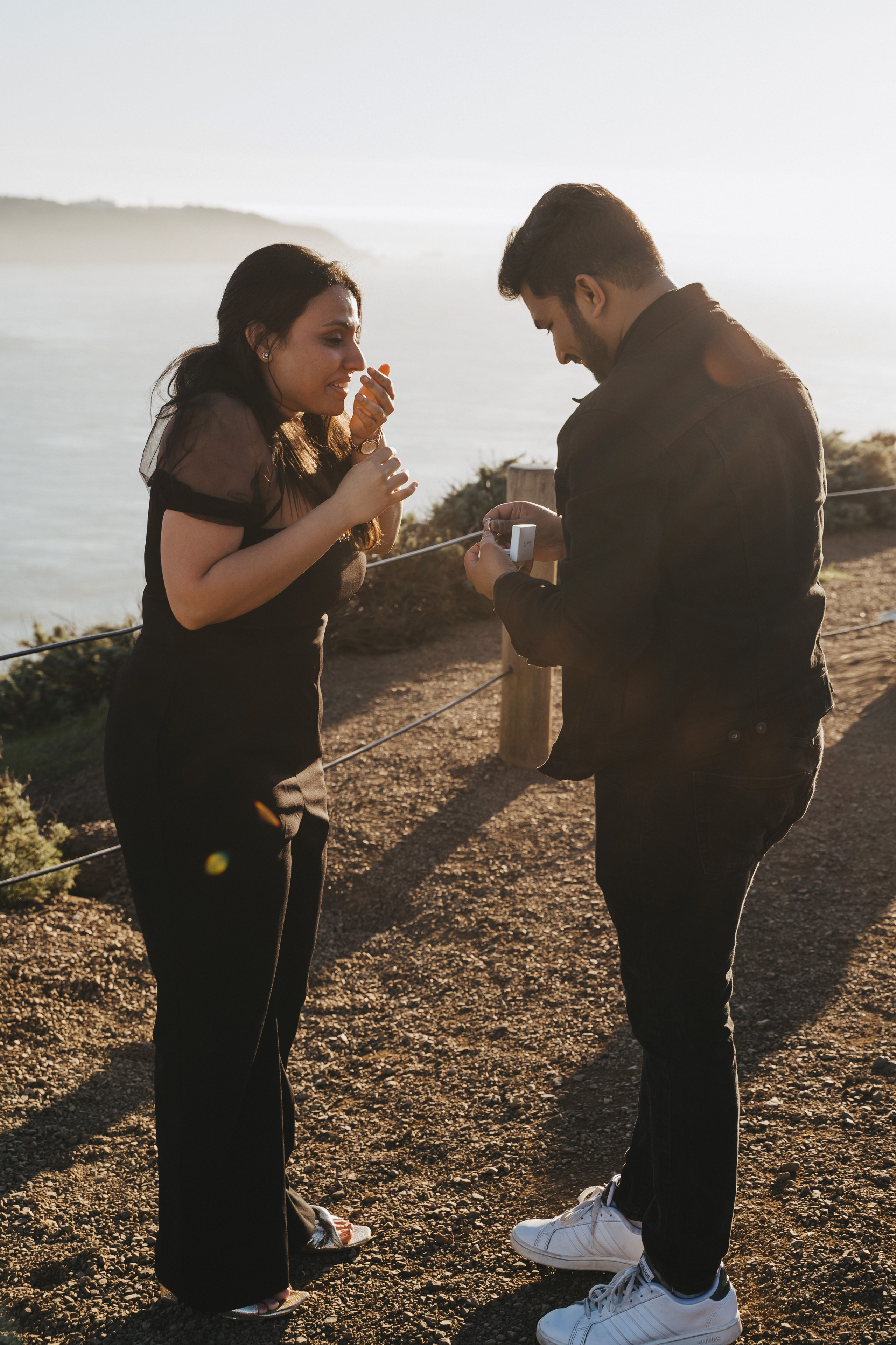 Proposal.  Overlooking the golden San Franisco Bridge sunset with a couple. Photographer Video. 