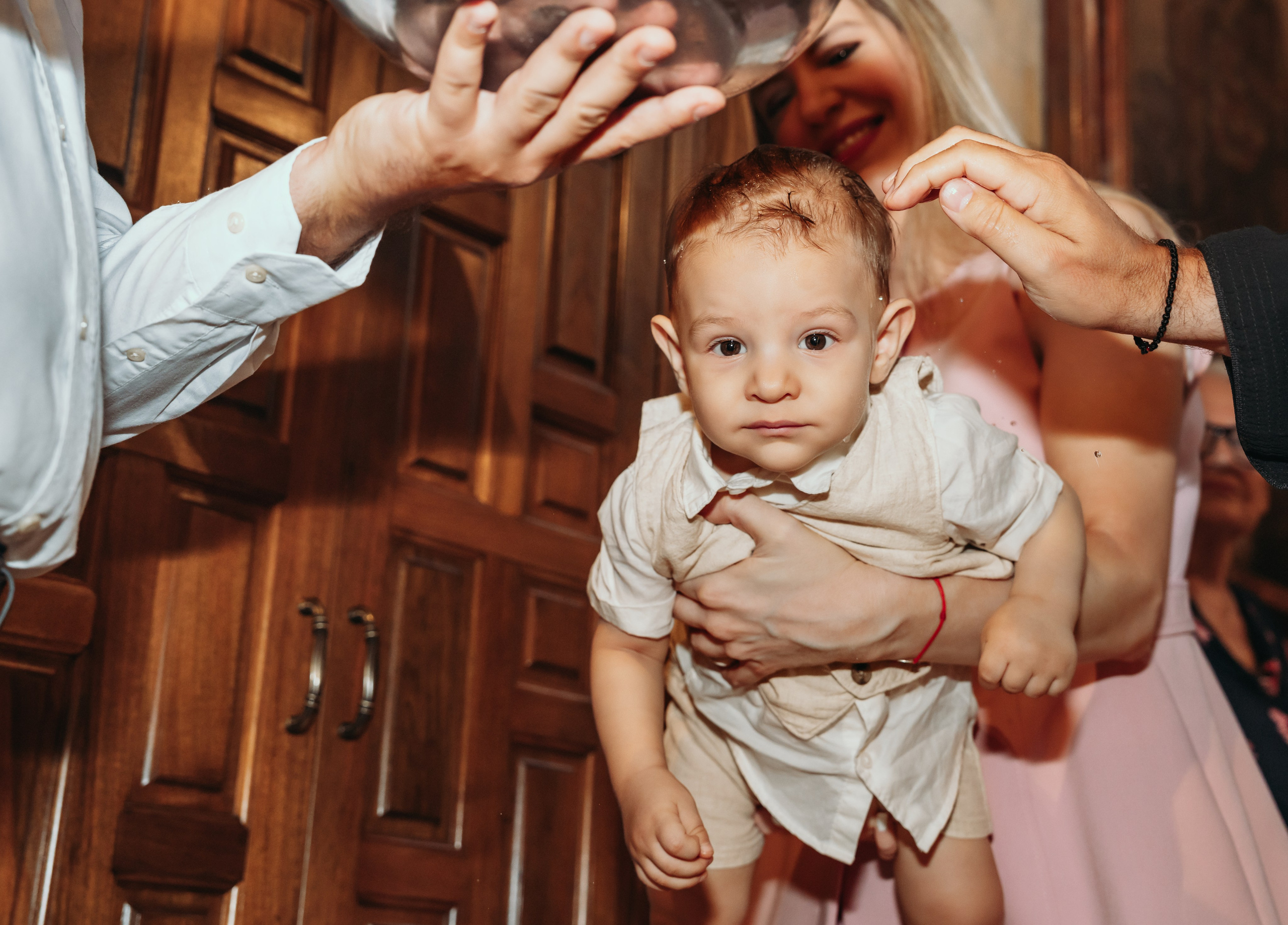 Beba gleda u fotoaparat na svom krstenju