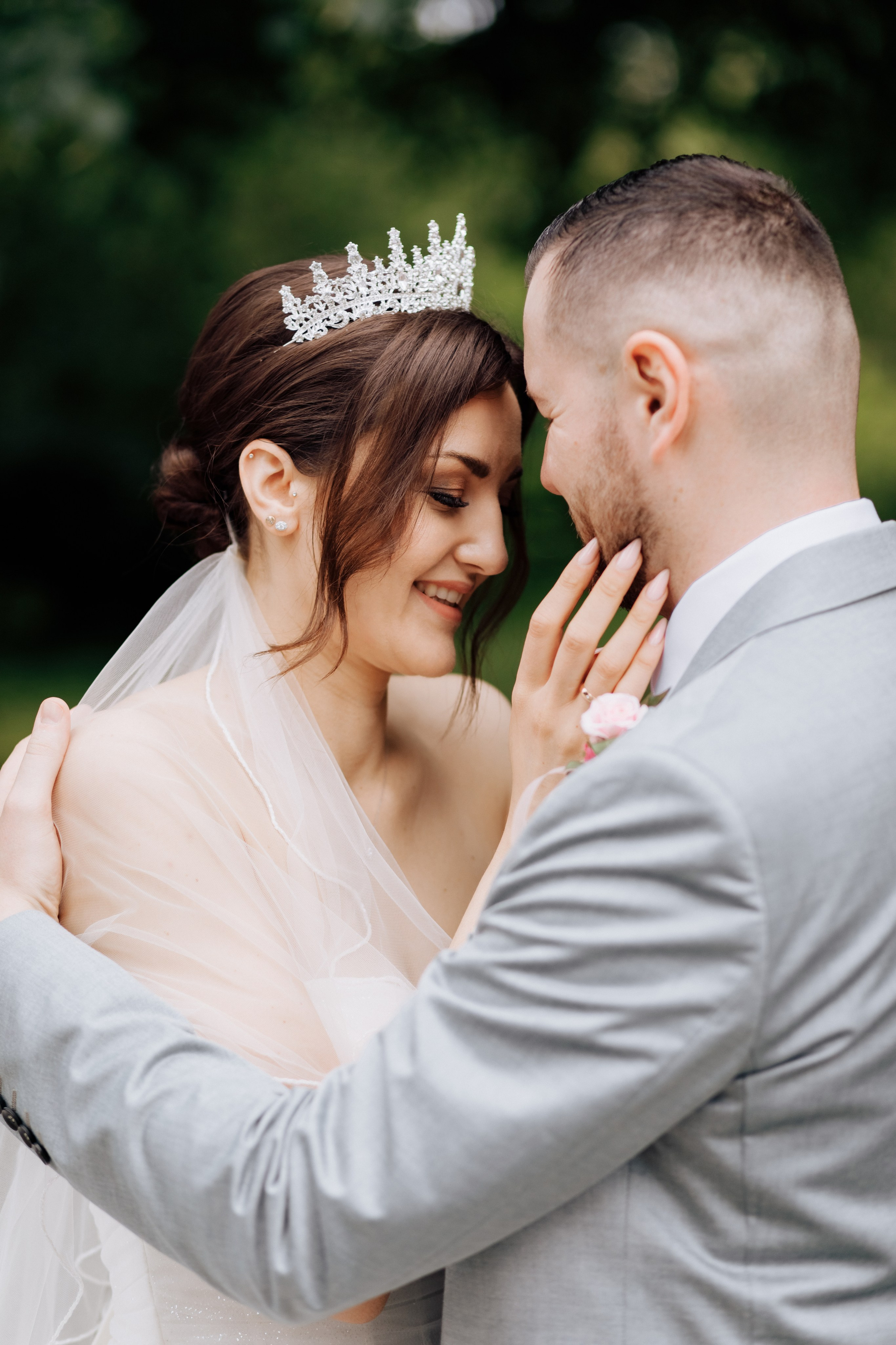 Die Braut umarmt den Bräutigam und lacht.