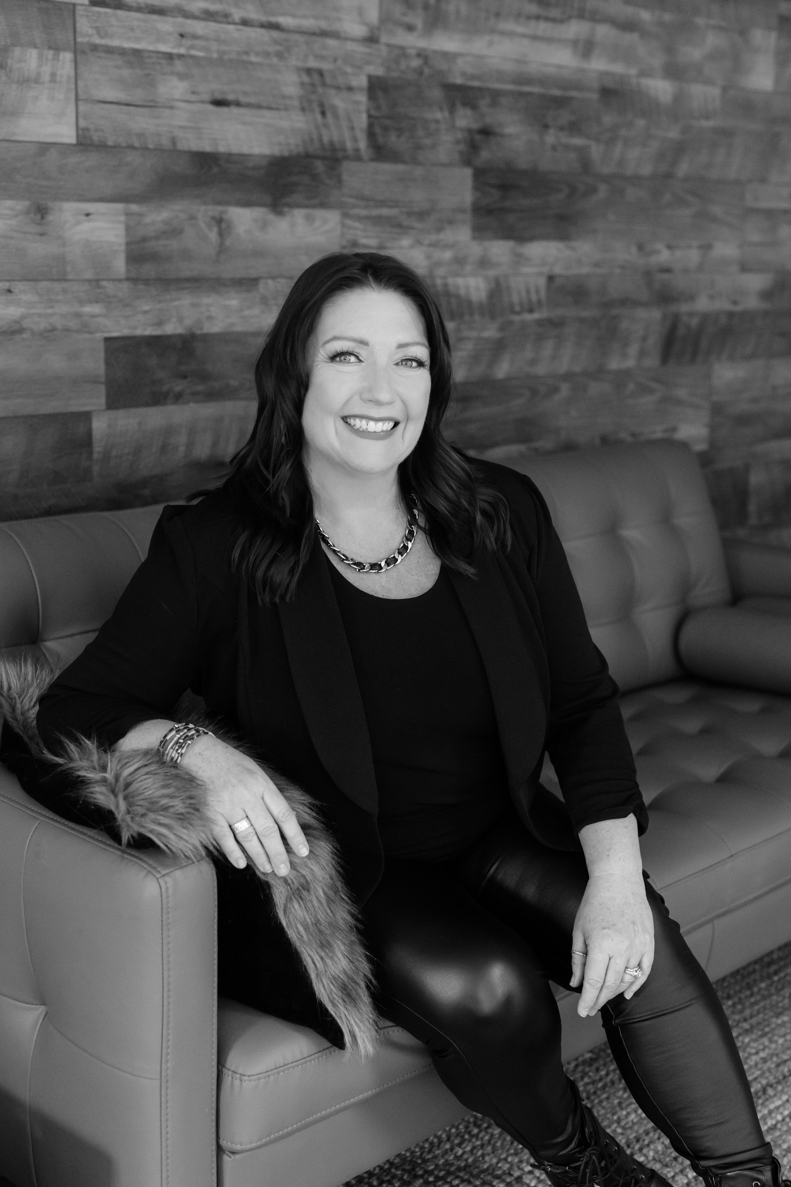 black and white image of woman smiling at camera 