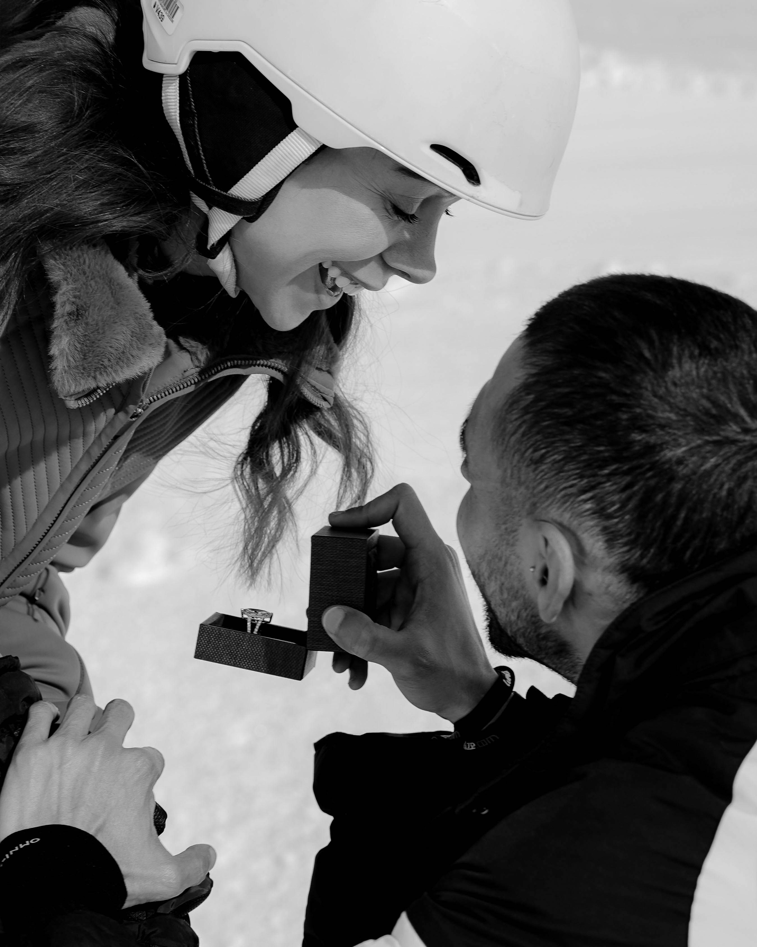 Close up proposal moment in snowy mountains