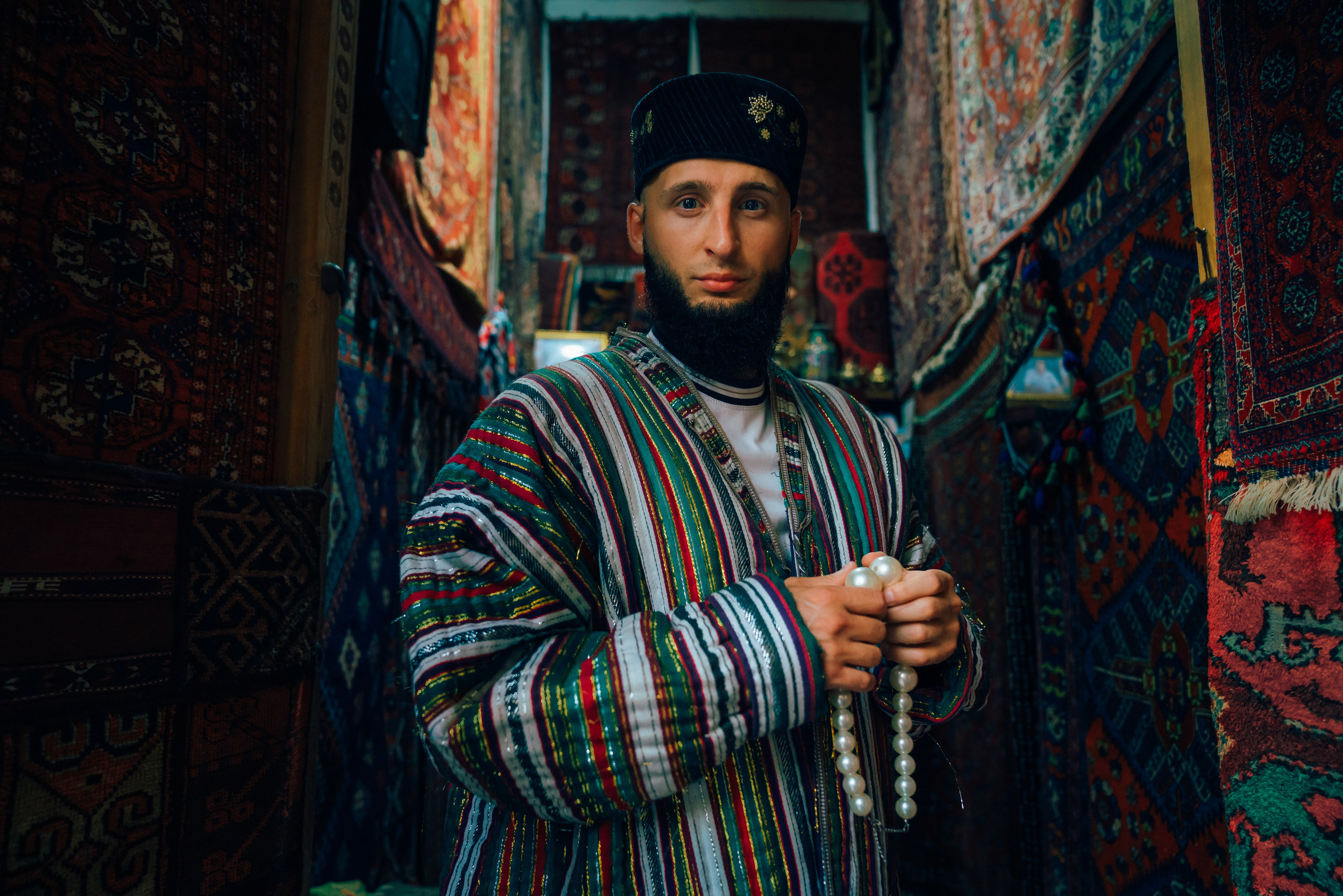 Man in traditional clothing near the monuments of Bukhara