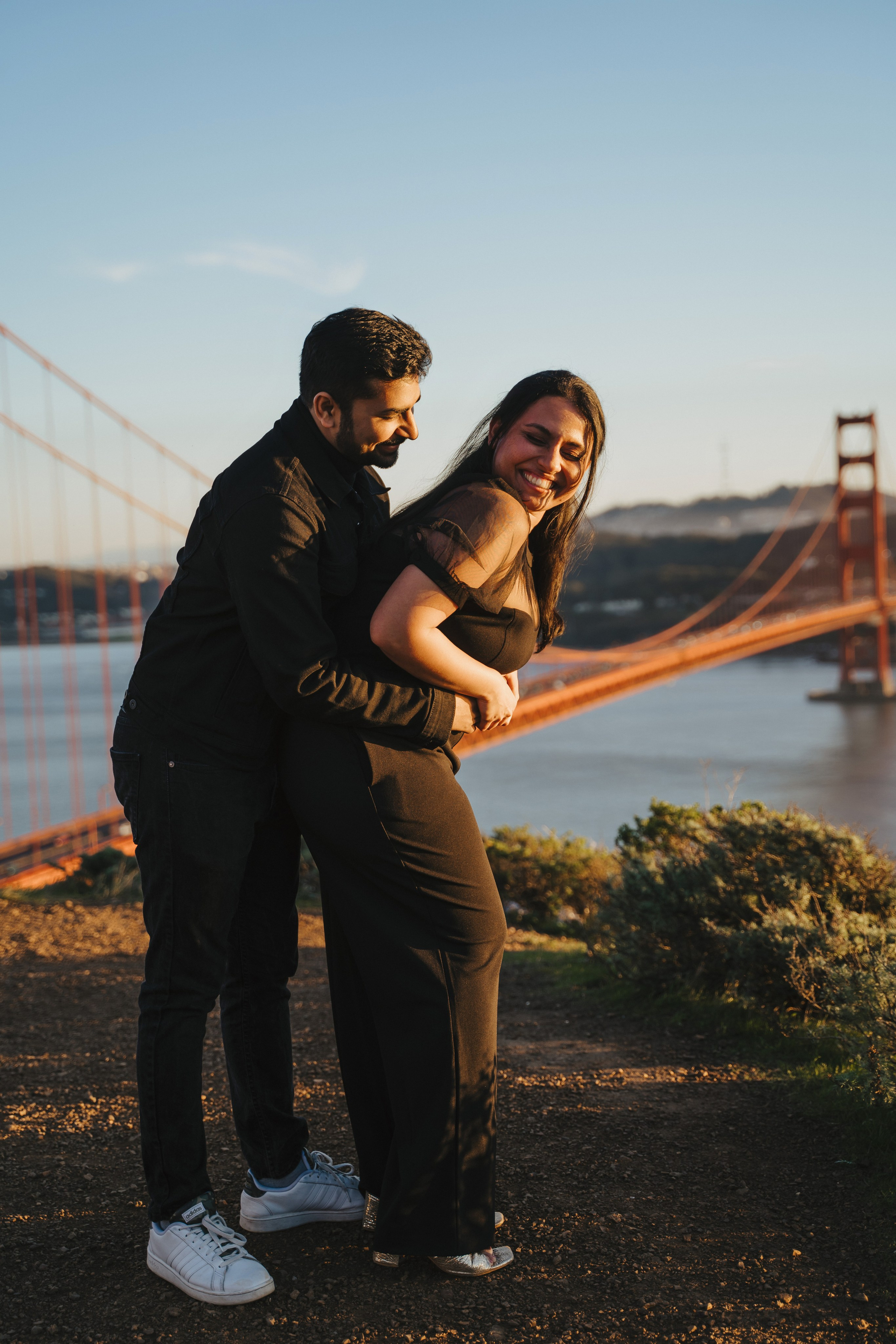 Proposal.  Overlooking the golden San Franisco Bridge sunset with a couple. Photographer Video. 