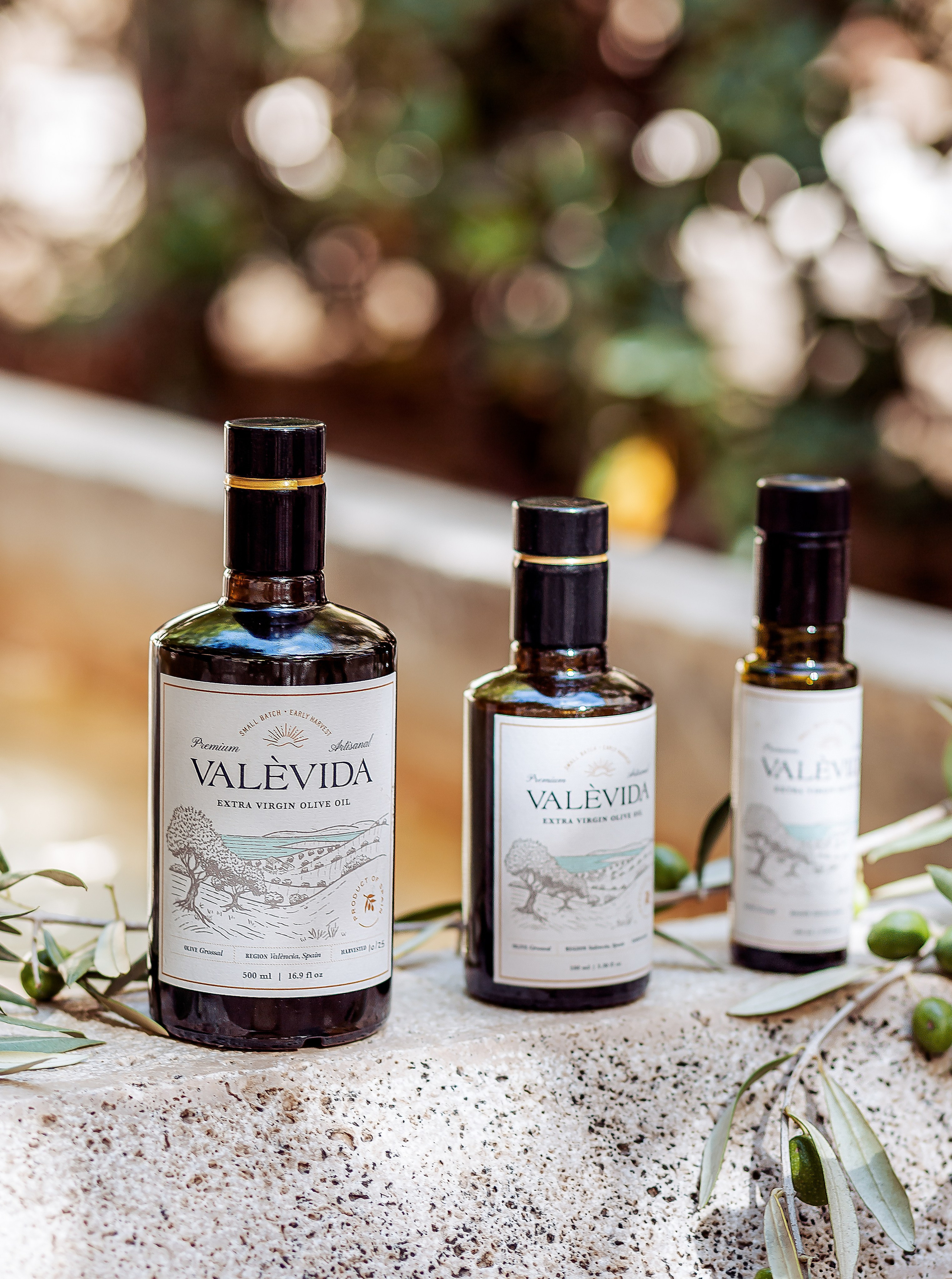 Elegant product photography of artisanal olive oil bottles captured in natural light in Valencia, Spain — ideal for brand, content, and product photoshoots that highlight Mediterranean lifestyle and premium packaging.