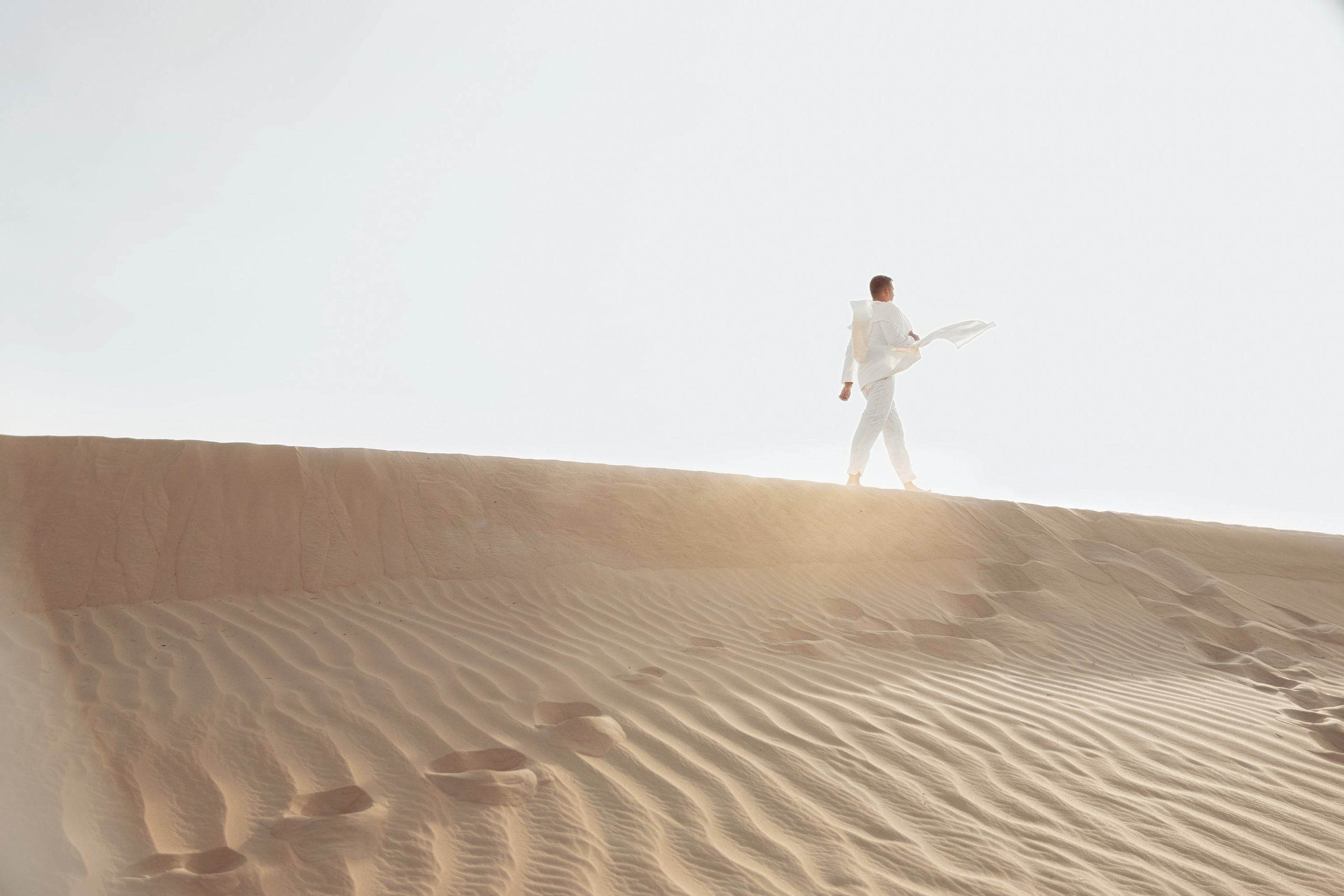 Groom is walking in a Dubai desert