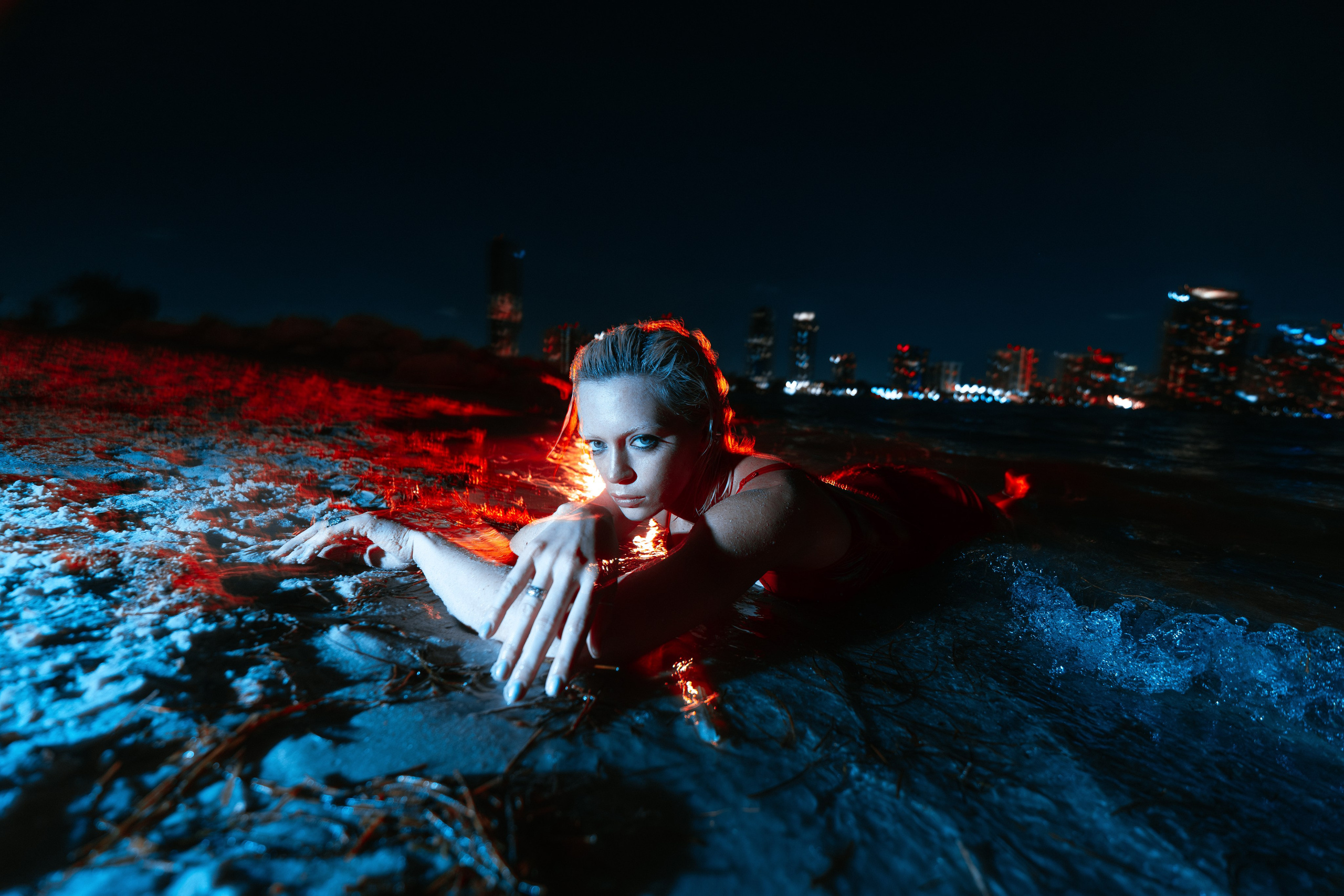 Night portrait in motion — long exposure captures the pulse of the city. The red dress emphasizes the silhouette while directional lighting creates bold lines. Shot by a Miami professional photographer, ideal for fashion and editorial use.