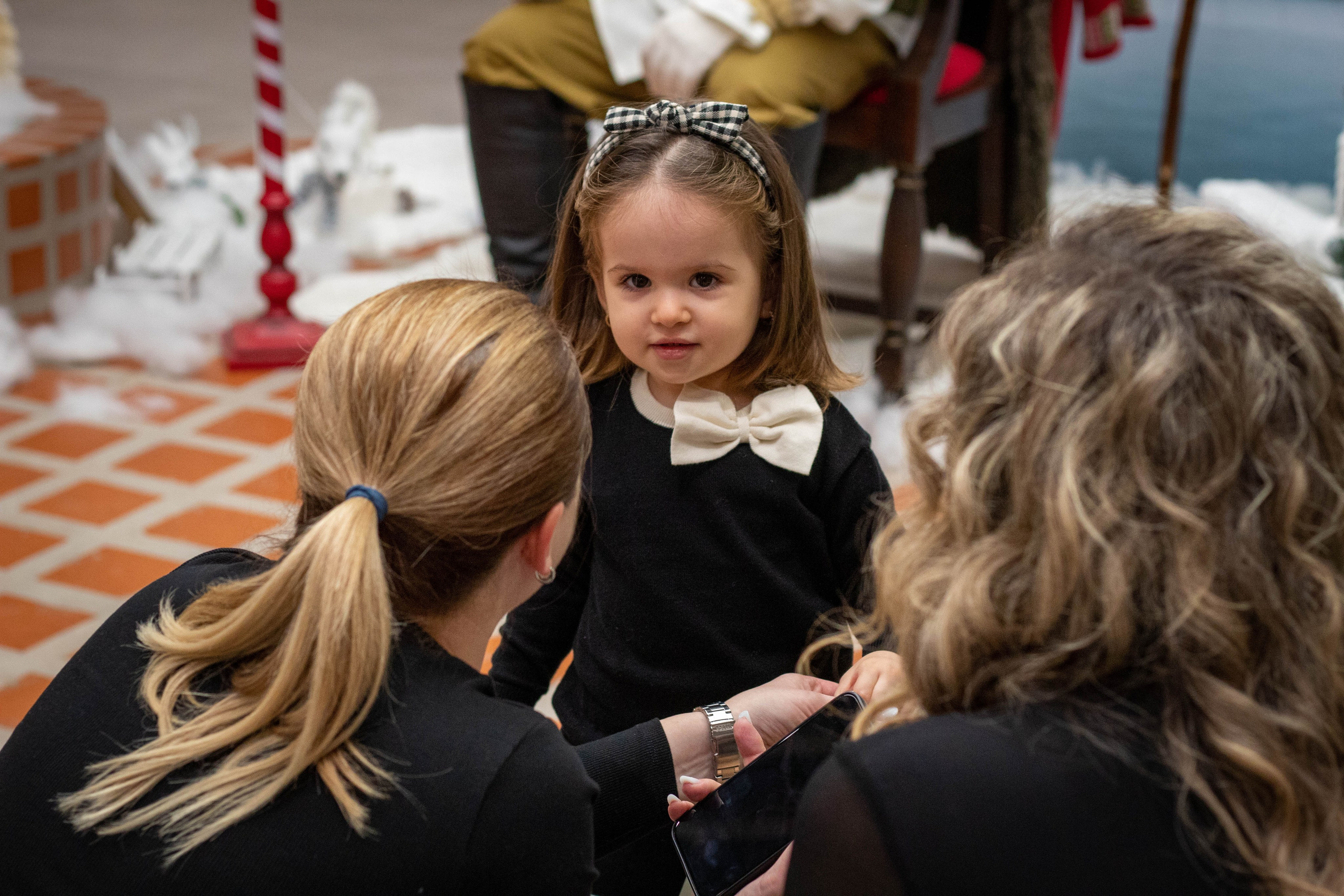 Elderly woman and young child interacting during a family gathering or celebration.