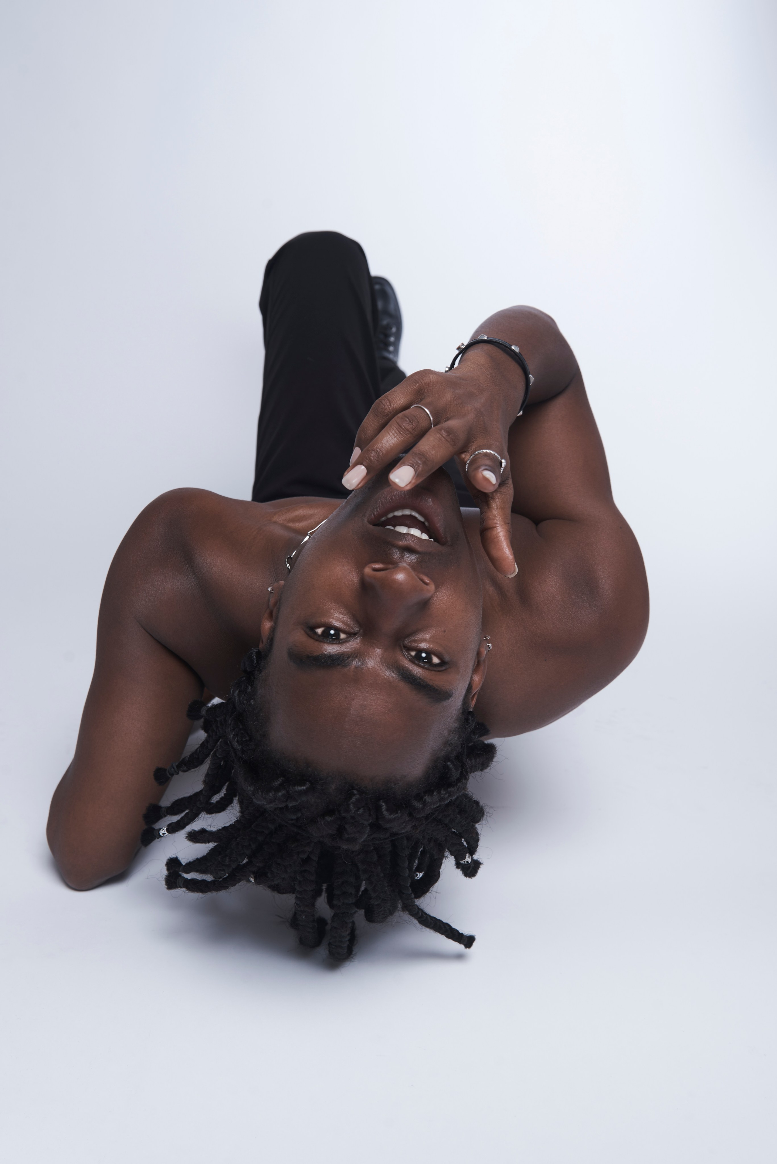 Singer framing his face with hands — creative headshot