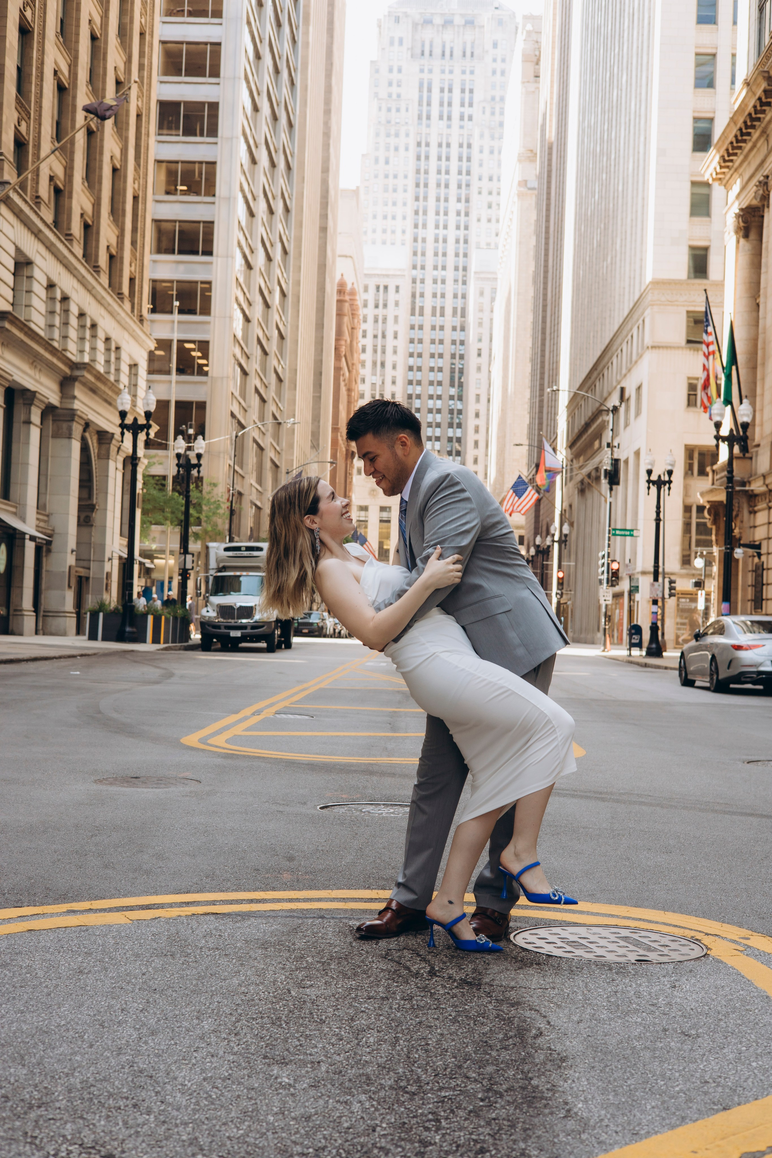 Wedding couple posing together in downtown Chicago with city skyline 