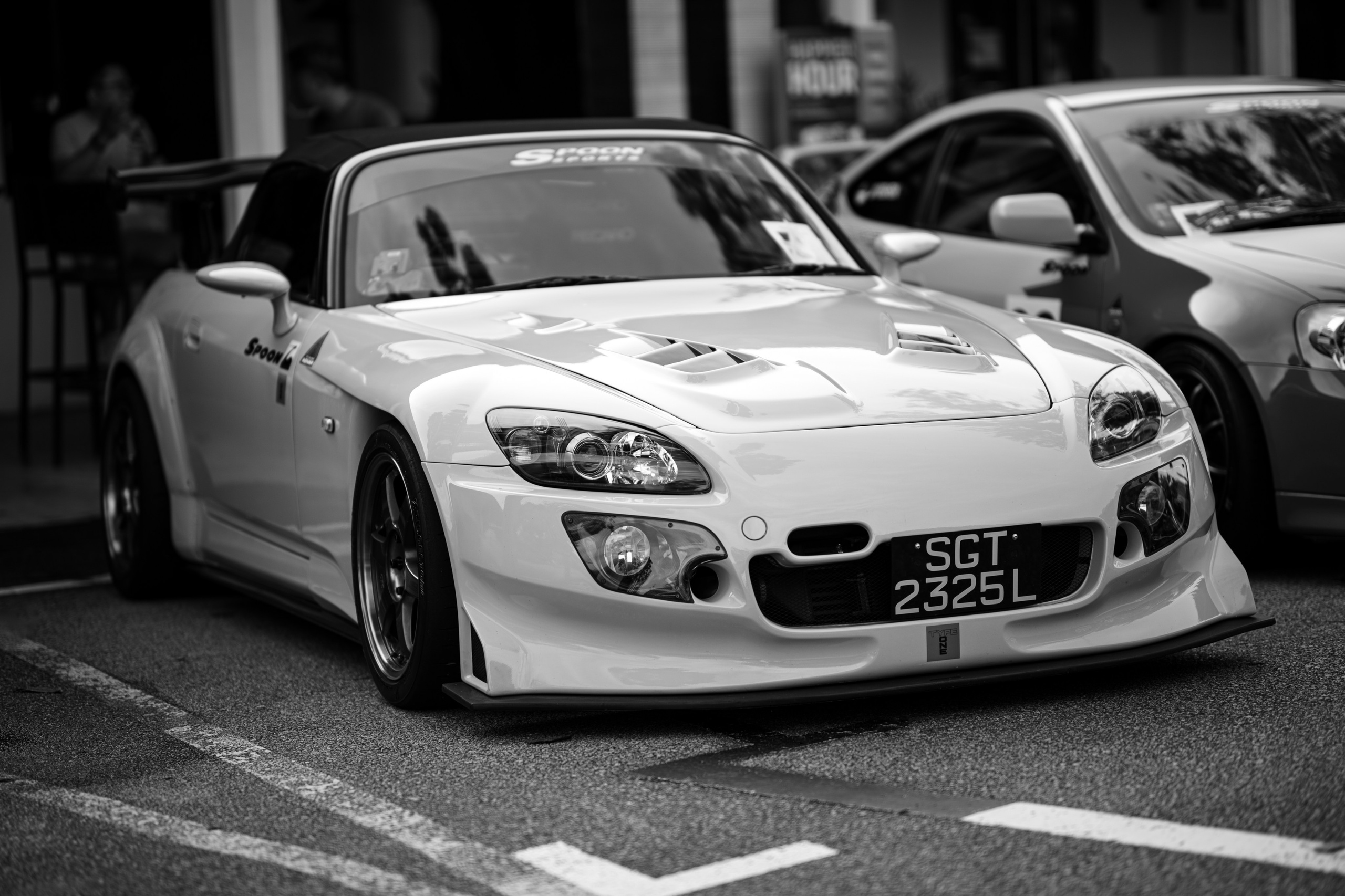 Honda S2000 Spoon wide-body – dynamic black-and-white street portrait of a modified Honda S2000 (SGT 2325L) at local car meet, illustrating creative performance-car photography for enthusiasts and commercial clients.