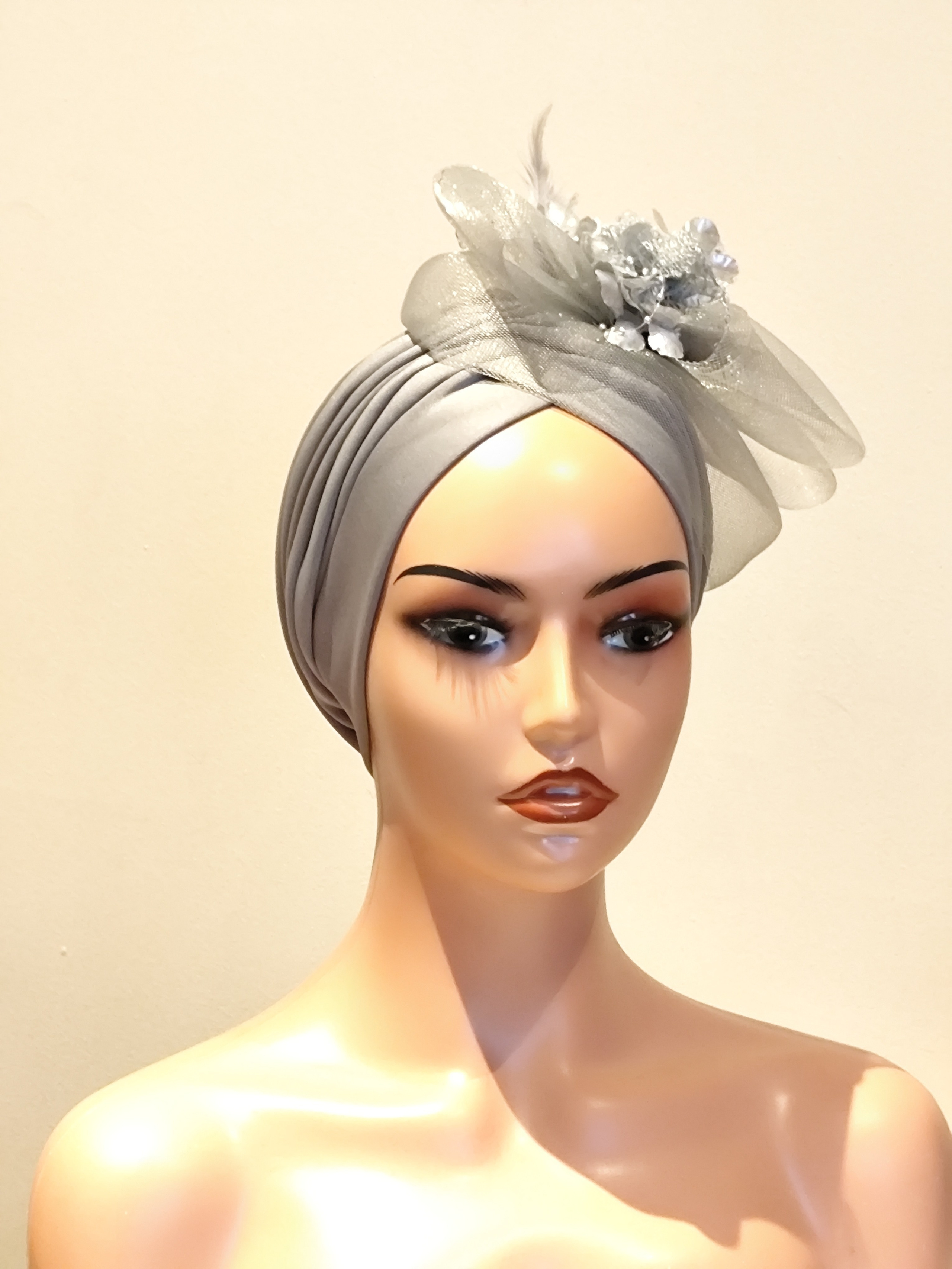 Pleated turban with attached fascinators. A milliner in Hull, UK Abimbola Okeyode