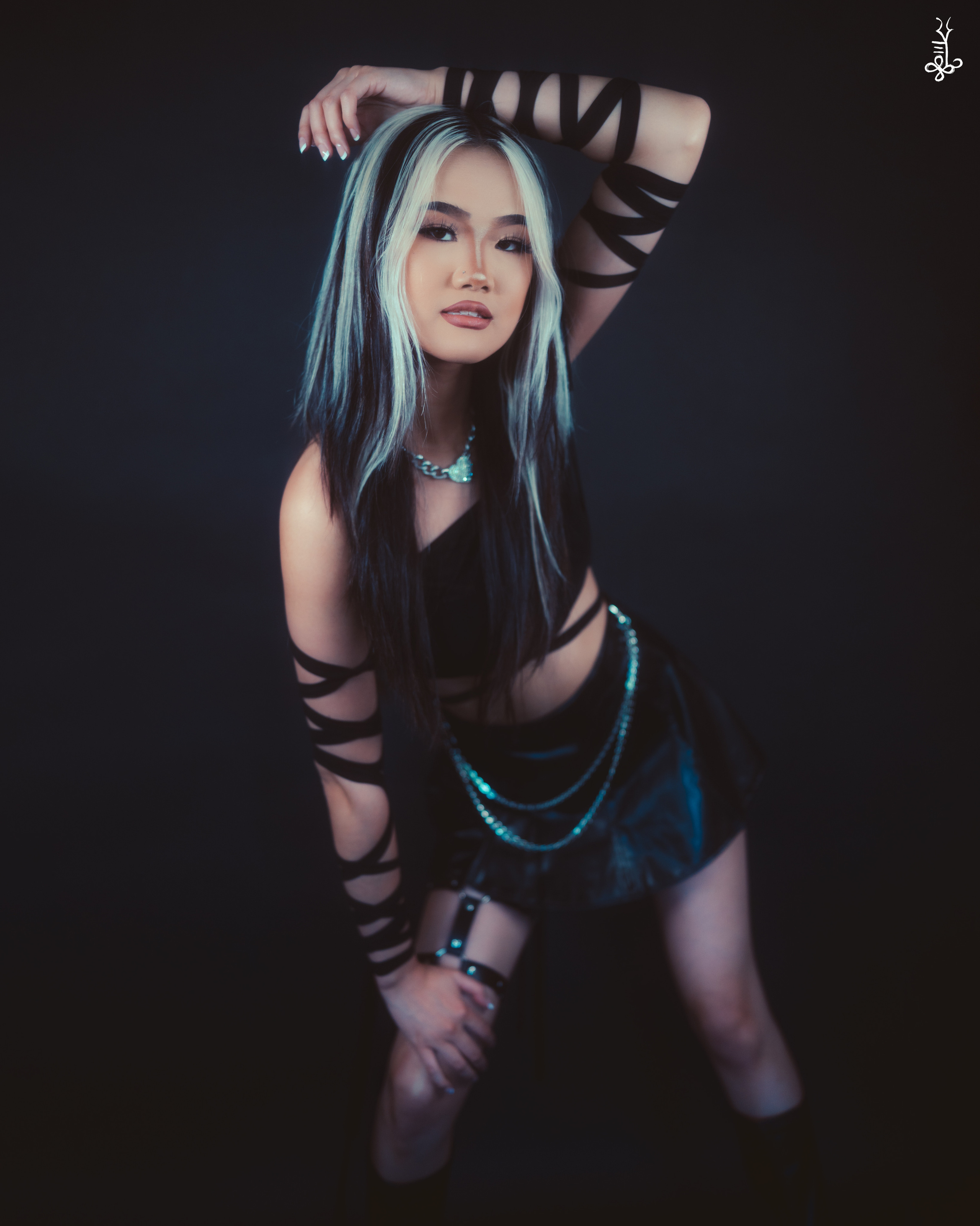 Model in dark gothic fashion looking directly at camera with intense expression